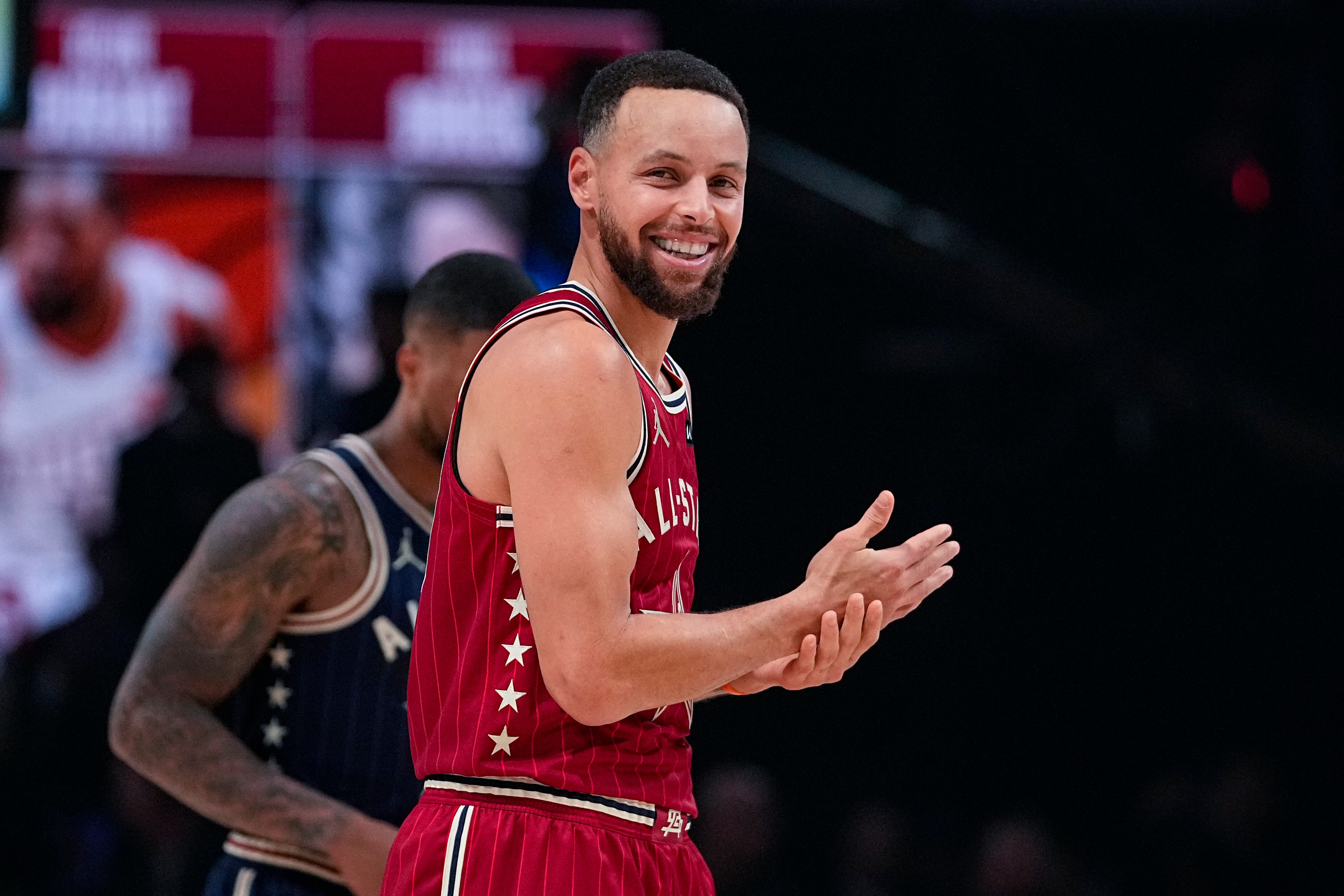 Golden State Warriors guard Stephen Curry (30) laughs as the crowd chants during a free throw attempt during the second half of an NBA All-Star basketball game in Indianapolis, Sunday, Feb. 18, 2024. (AP Photo/Darron Cummings)