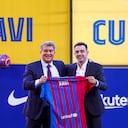 FC Barcelona's new signing coach Xavi Hernandez, right, poses next to FC Barcelona president Joan Laporta during his official presentation at the Camp Nou stadium in Barcelona, Spain, Monday, Nov. 8, 2021. Xavi, who thrived in Barcelona's midfield alongside Messi and Andres Iniesta, was officially introduced as coach on the field of the Camp Nou with a reception usually only offered to top players. (AP Photo/Joan Monfort)