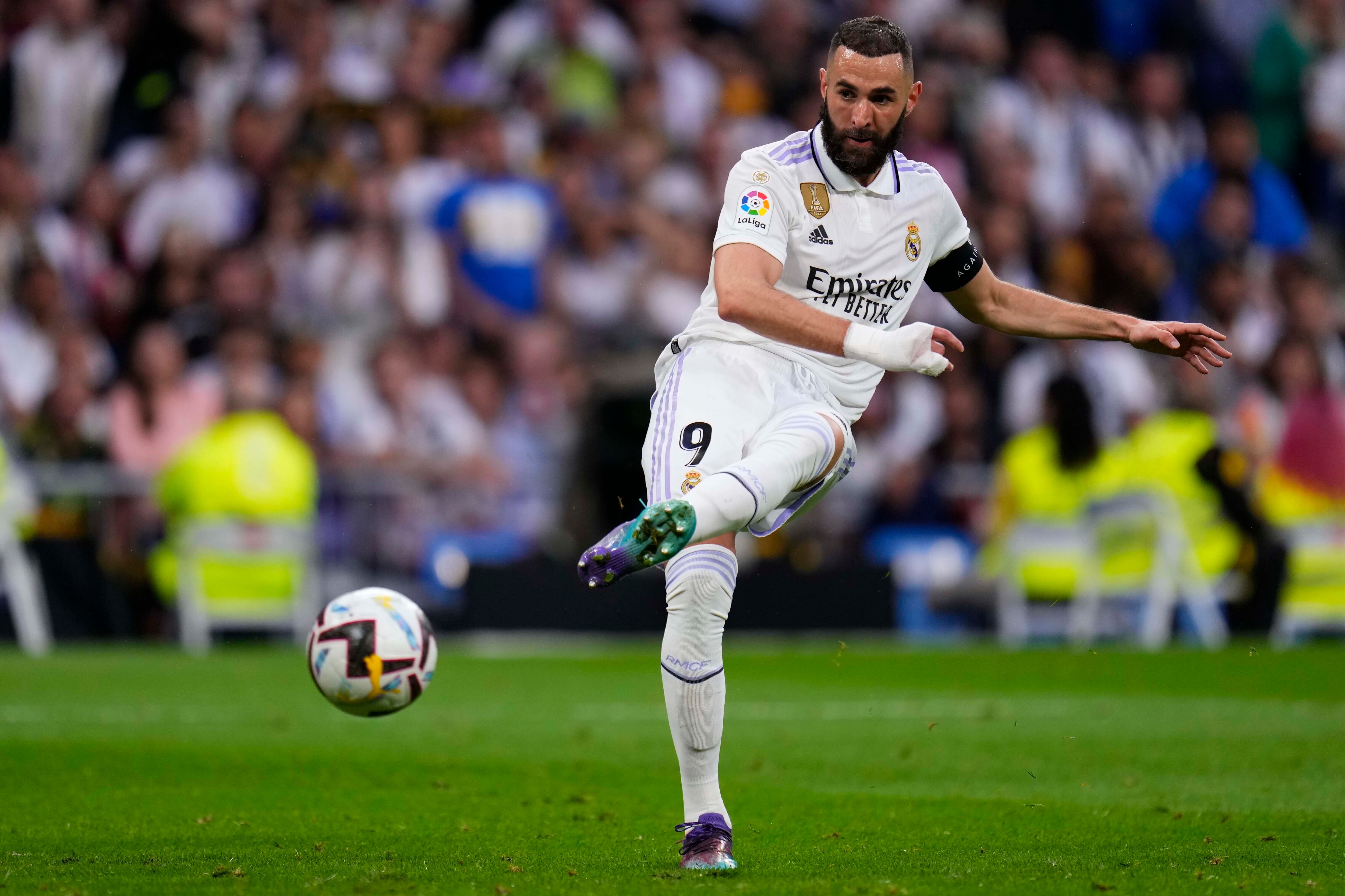 Real Madrid's Karim Benzema kicks the ball during a Spanish La Liga soccer match between Real Madrid and Rayo Vallecano at the Santiago Bernabeu stadium in Madrid, Spain, Wednesday, May 24, 2023. (AP Photo/Manu Fernandez)