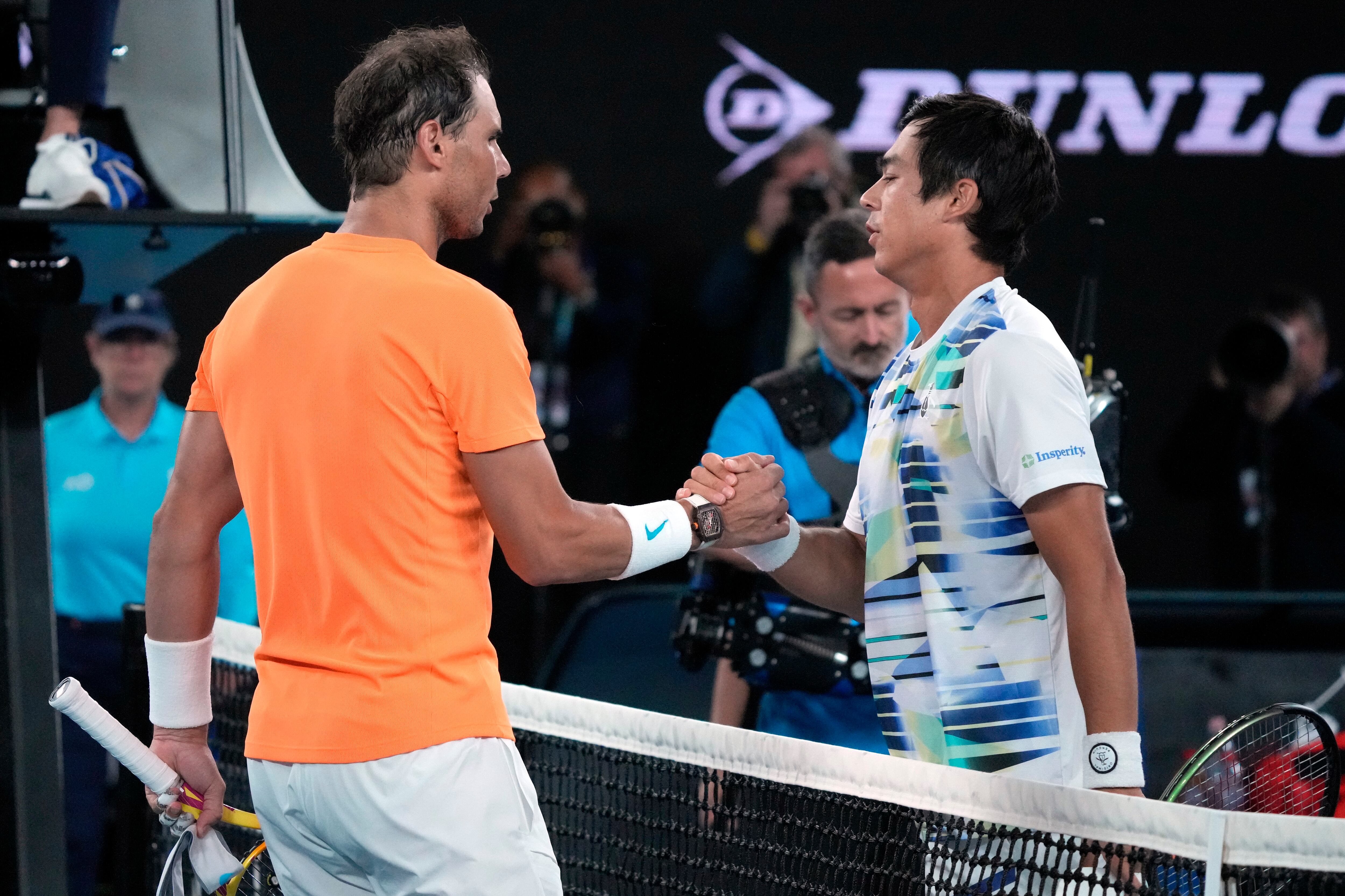 Rafael Nadal, left, of Spain congratulates Mackenzie McDonald of the U.S., following their second round match at the Australian Open tennis championship in Melbourne, Australia, Wednesday, Jan. 18, 2023. (AP Photo/Dita Alangkara)