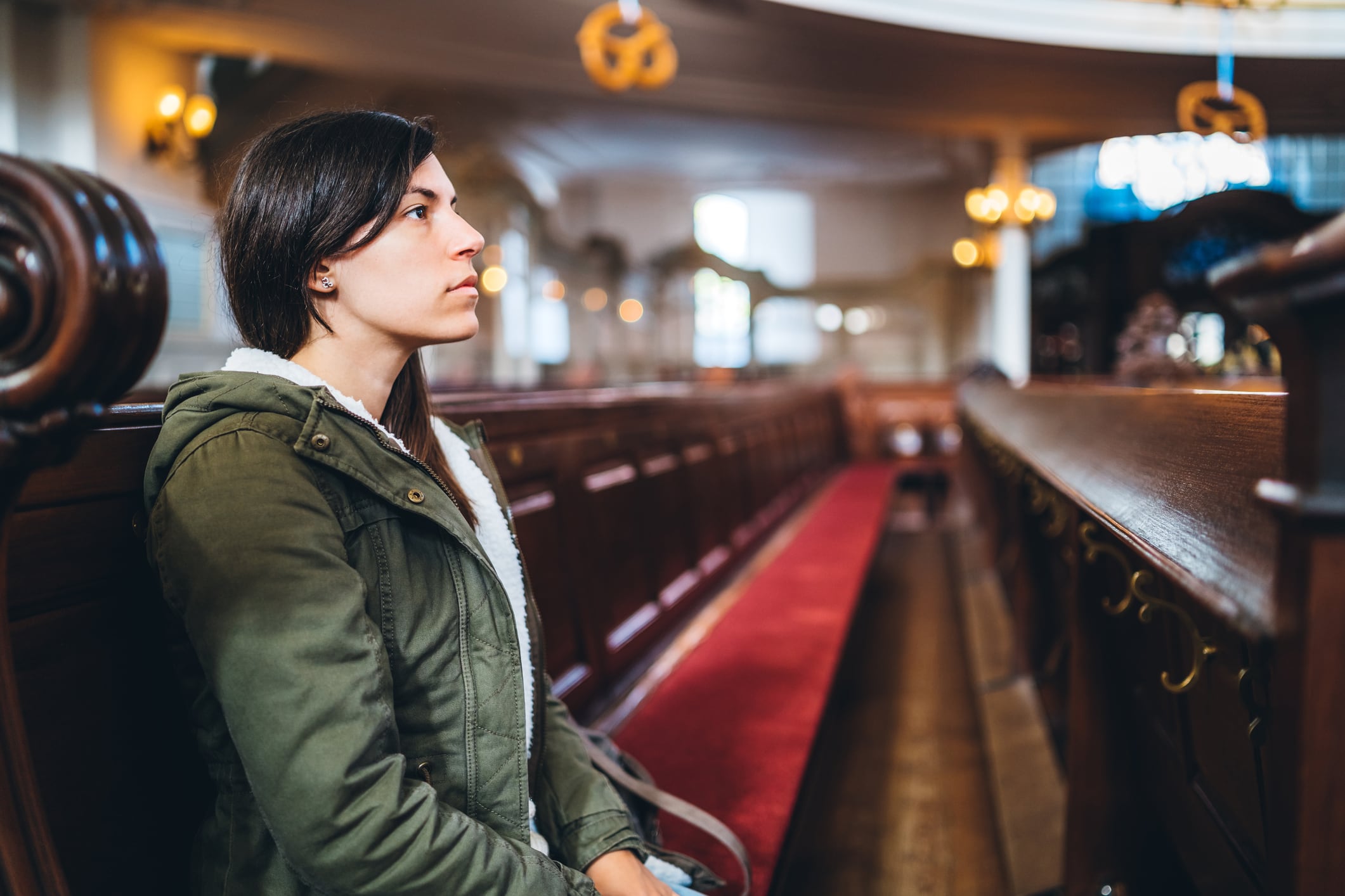 Young woman is attending religious service in Saint Michael church, Hamburg.
