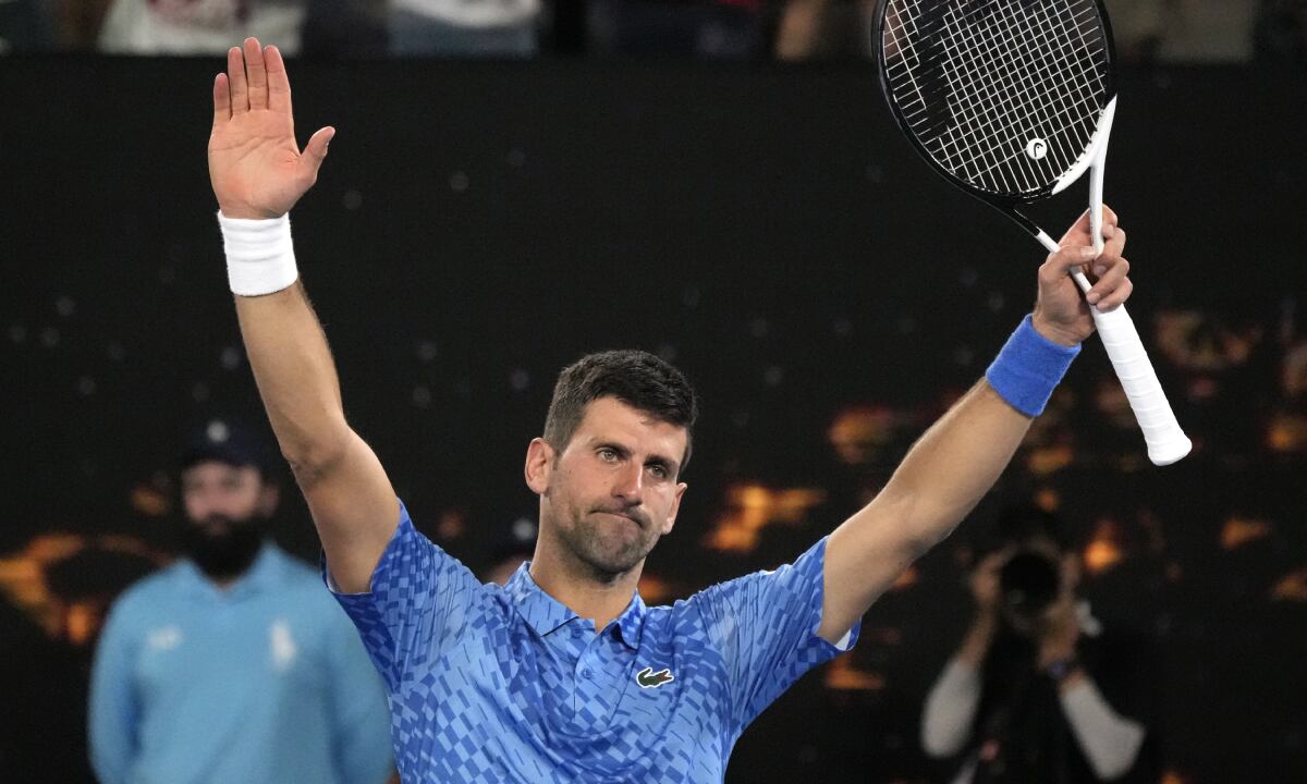 Novak Djokovic of Serbia plays a backhand return to Alex de Minaur of Australia during their fourth round match at the Australian Open tennis championship in Melbourne, Australia, Monday, Jan. 23, 2023. (AP/Aaron Favila)