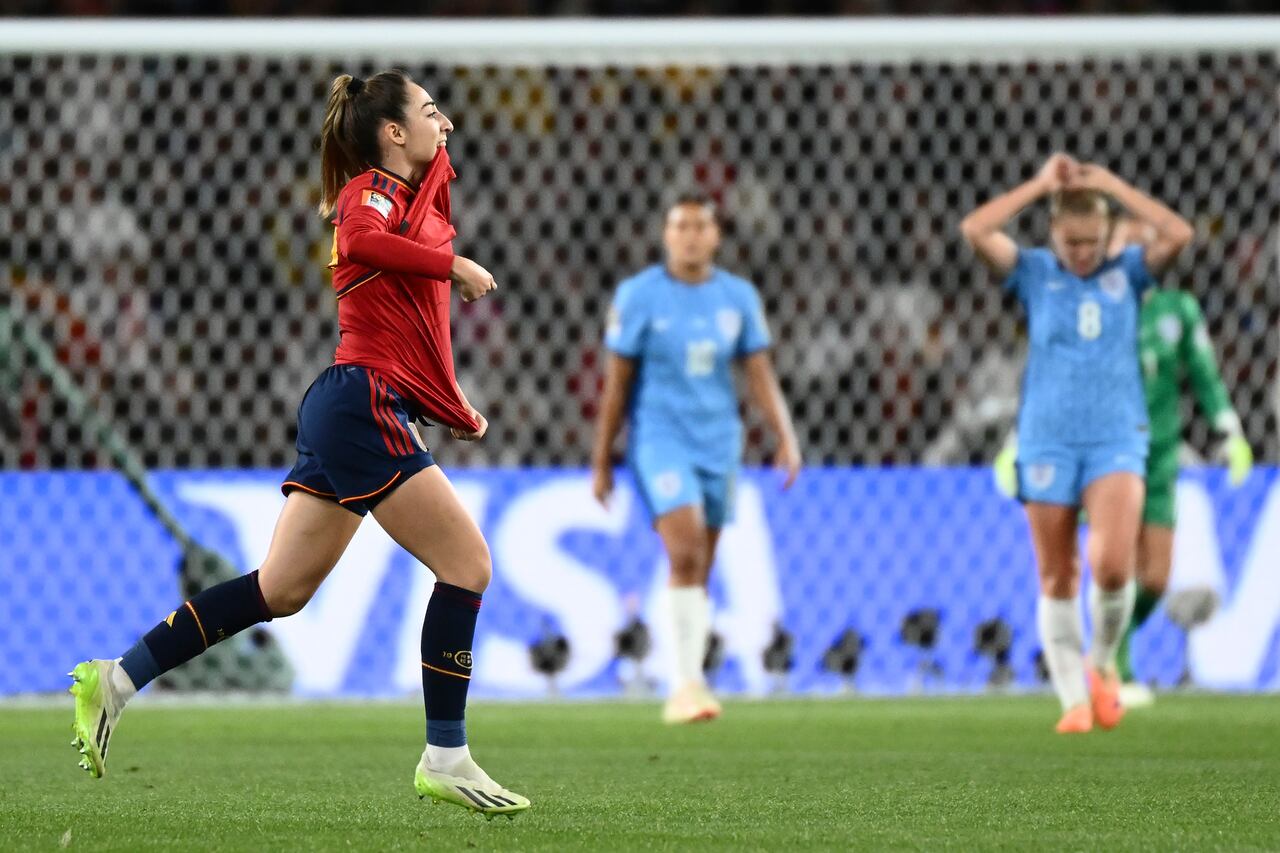 Spain's Olga Carmona, left, celebrates after scoring the opening goal during the Women's World Cup soccer final between Spain and England at Stadium Australia in Sydney, Australia, Sunday, Aug. 20, 2023. (AP Photo/Steve Markham)