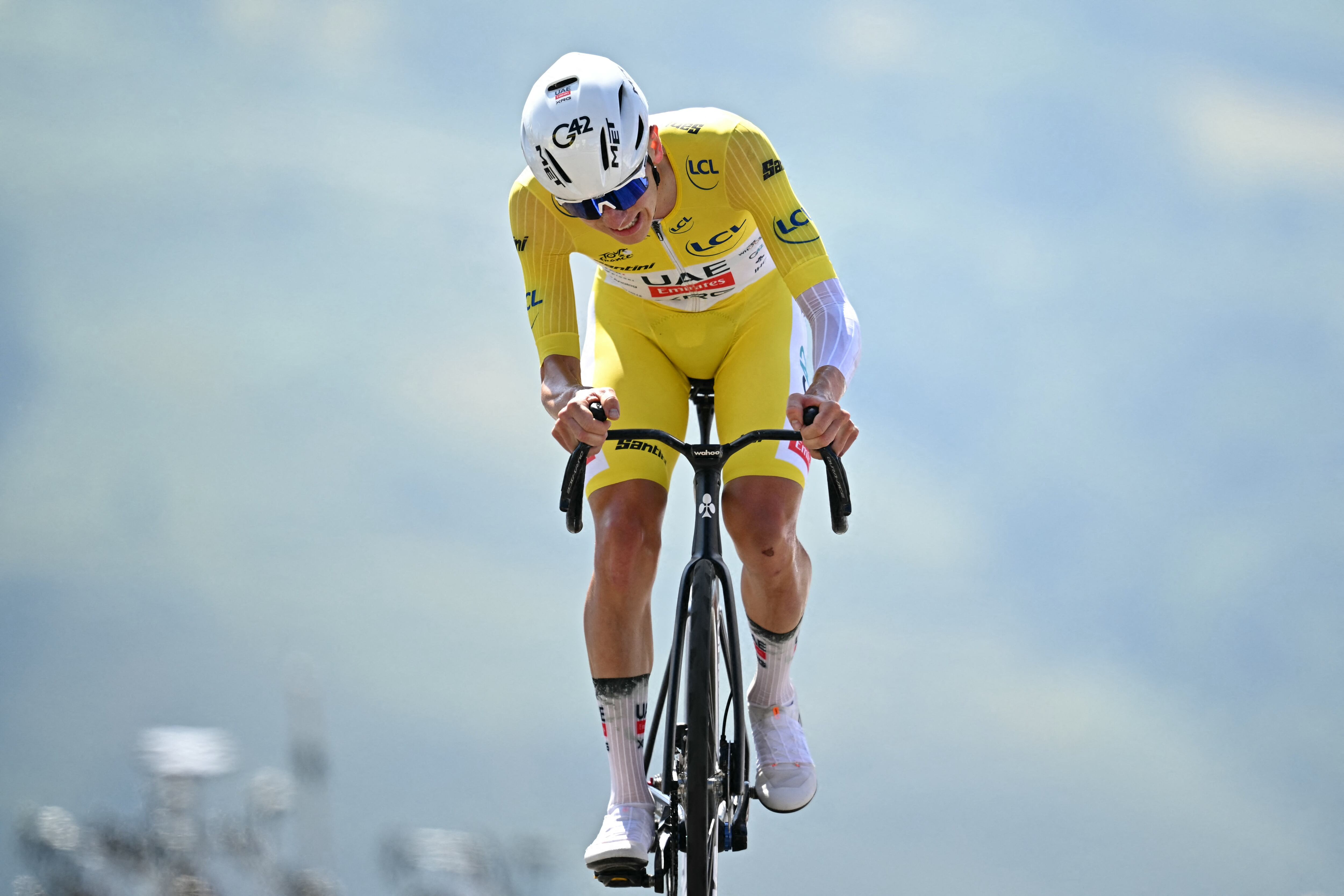 UAE Team Emirate - XRG team's Slovenian rider Tadej Pogacar wearing the overall leader's yellow jersey cycles to the finish line to win the 13th stage of the 112th edition of the Tour de France cycling race, 10.9 km individual time trial between Loudenvielle and Peyragudes, in the Pyrenees mountains of southwestern France, on July 18, 2025. (Photo by Loic VENANCE / AFP)