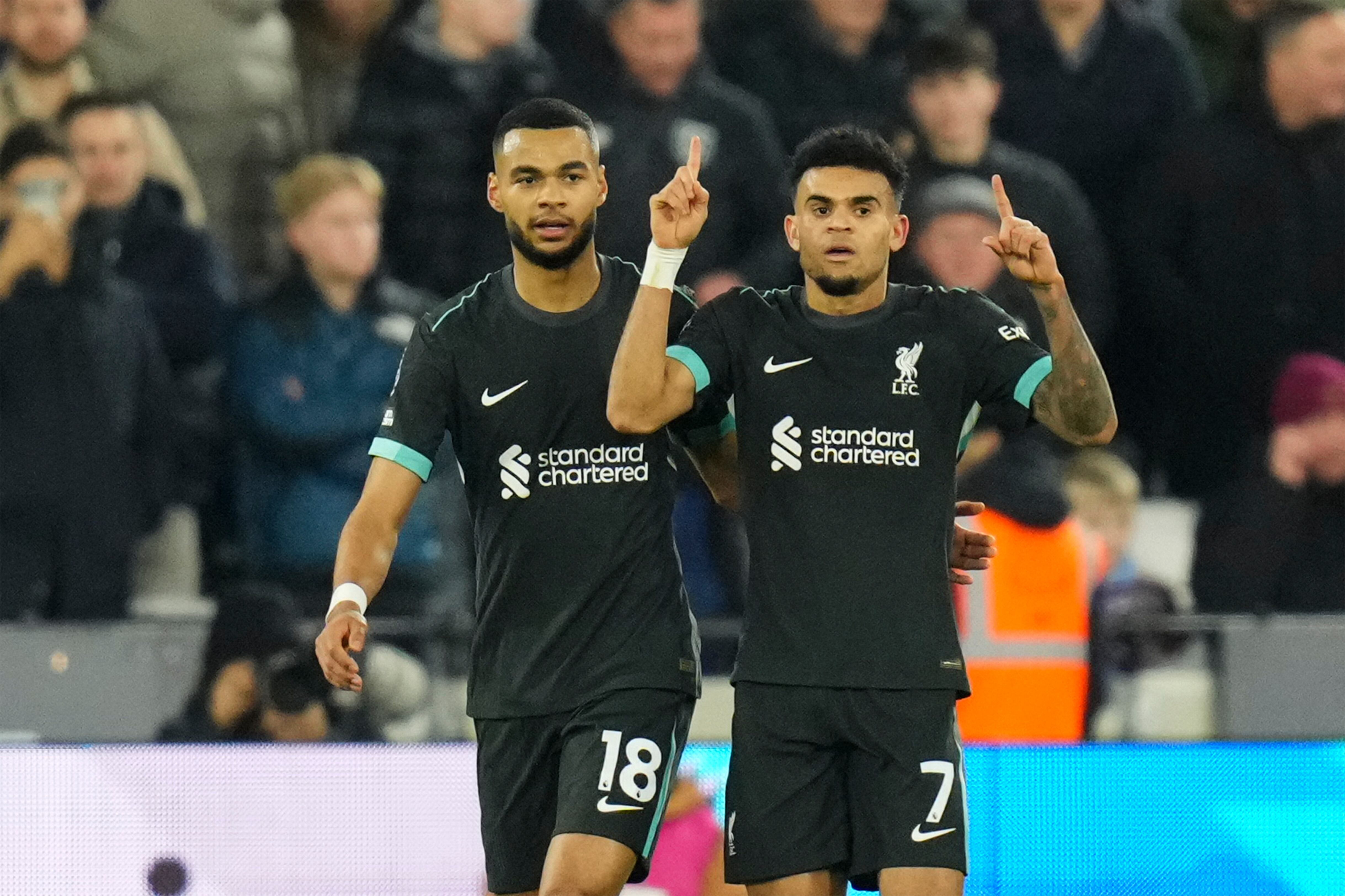 Liverpool's Luis Diaz, right, celebrates with teammate Cody Gakpo after scoring the opening goal during the English Premier League soccer match between West Ham United and Liverpool at the London Stadium in London, Sunday, Dec. 29, 2024. (AP Photo/Kirsty Wigglesworth)