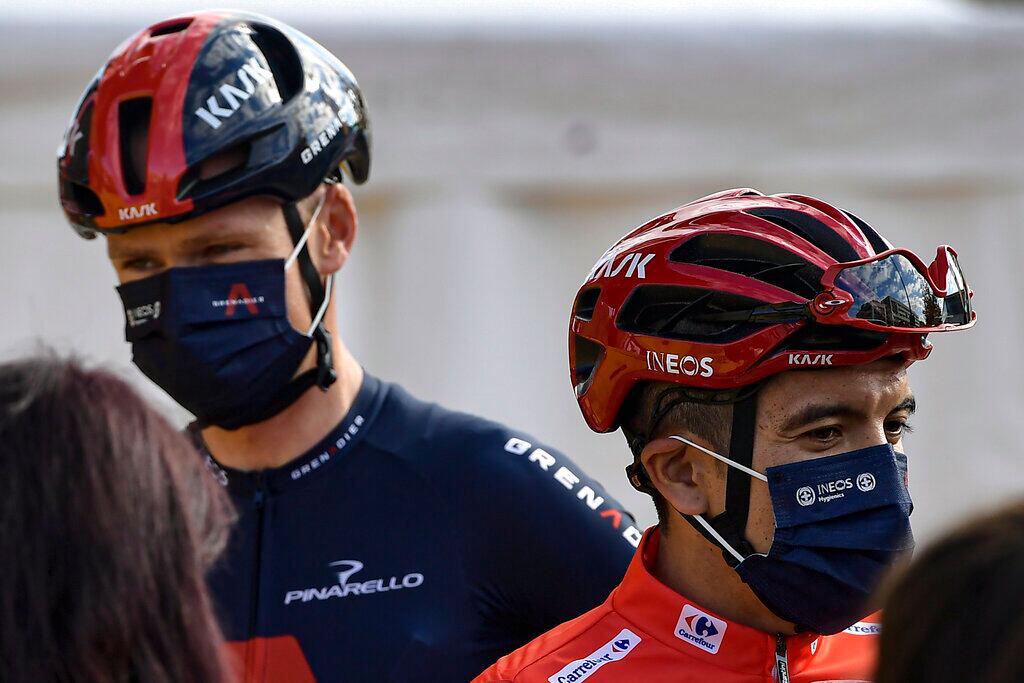 Ineos's Richard Carapaz, red shirt leader of La Vuelta, right, talks to the media close to Chris Froome during checkpoint control before starting the eighth stage of La Vuelta between Logrono and Alto de Moncalvillo, in Logrono, northern Spain, Wednesday, Oct. 28, 2020. (AP Photo/Alvaro Barrientos)