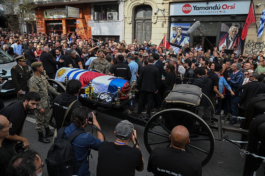 MONTEVIDEO, URUGUAY - MAY 14: The funeral cortege of former President of Uruguay Jose 'Pepe' Mujica passes in front of the Movimiento de Participación Popular (MPP) party headquarters on May 14, 2025, in downtown Montevideo, Uruguay. Jose Mujica was born on May 20, 1935 in Montevideo and led Uruguay as president from 2010 to 2015. Mujica was involved in politics since his youth, he was militant of the National Party and member of the group "Movimiento de Liberación Nacional-Tupamaros" a guerrilla group founded in the 60's. Often, 'Pepe' Mujica was called the 'Poorest President' of the world due to his modest lifestyle. The former president died on May 13. (Photo by Guillermo Legaria/Getty Images)