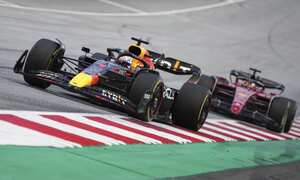 Red Bull driver Max Verstappen, left, of the Netherlands, steers his car followed by Ferrari driver Charles Leclerc, of Monaco, during the Austrian F1 Grand Prix at the Red Bull Ring racetrack in Spielberg, Austria, Sunday, July 10, 2022. (AP Photo/Matthias Schrader)