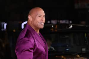 Dwayne Johnson poses for photographers upon arrival for the premiere of the film 'Black Adam' on Tuesday, Oct. 18, 2022, in London. (Photo by Vianney Le Caer/Invision/AP)
