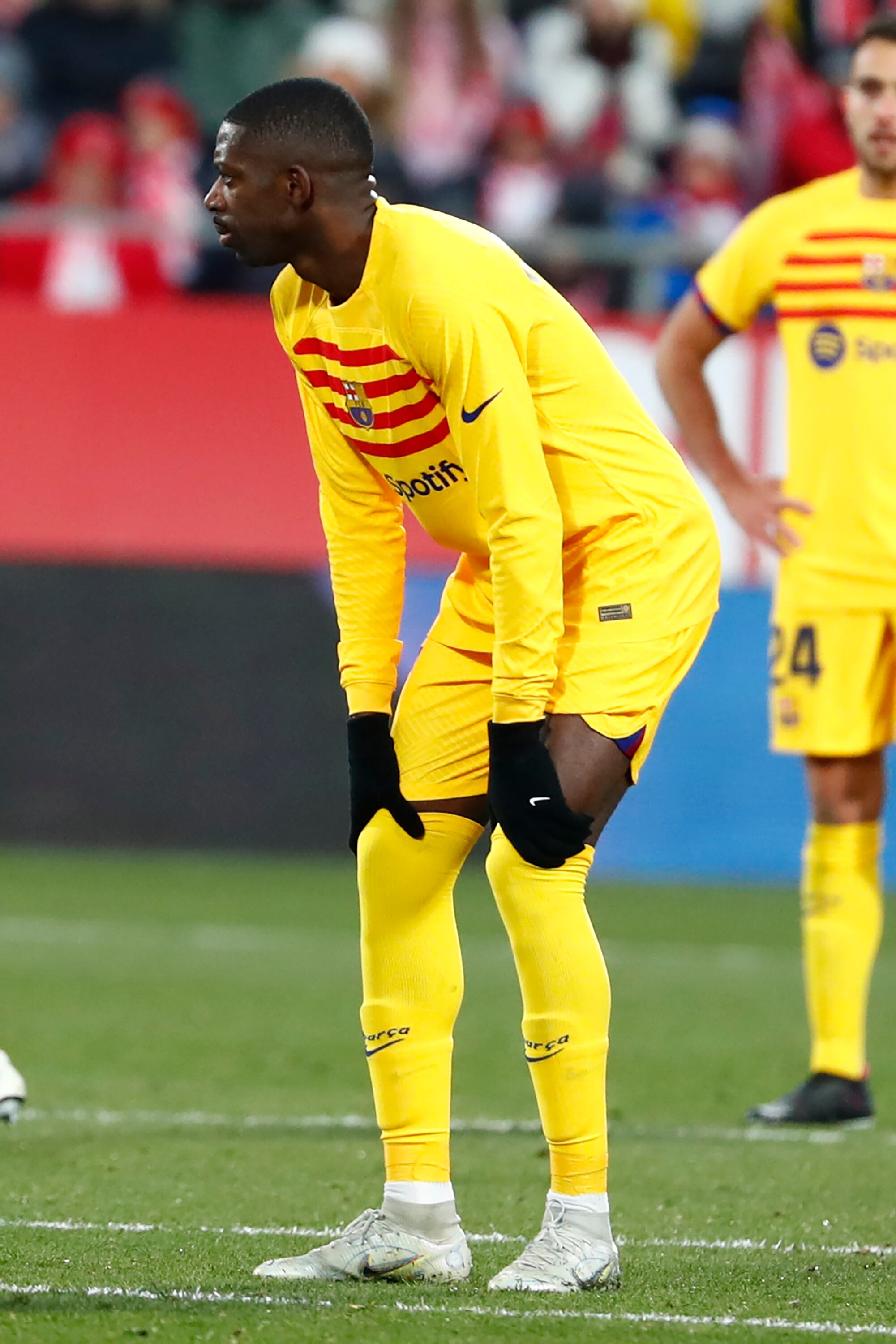 Barcelona's Ousmane Dembele hold his knees after being injured during the Spanish La Liga soccer match between Girona and FC Barcelona at the Montilivi stadium in Girona, Spain, Saturday, Jan. 28, 2023. (AP Photo/Joan Monfort)