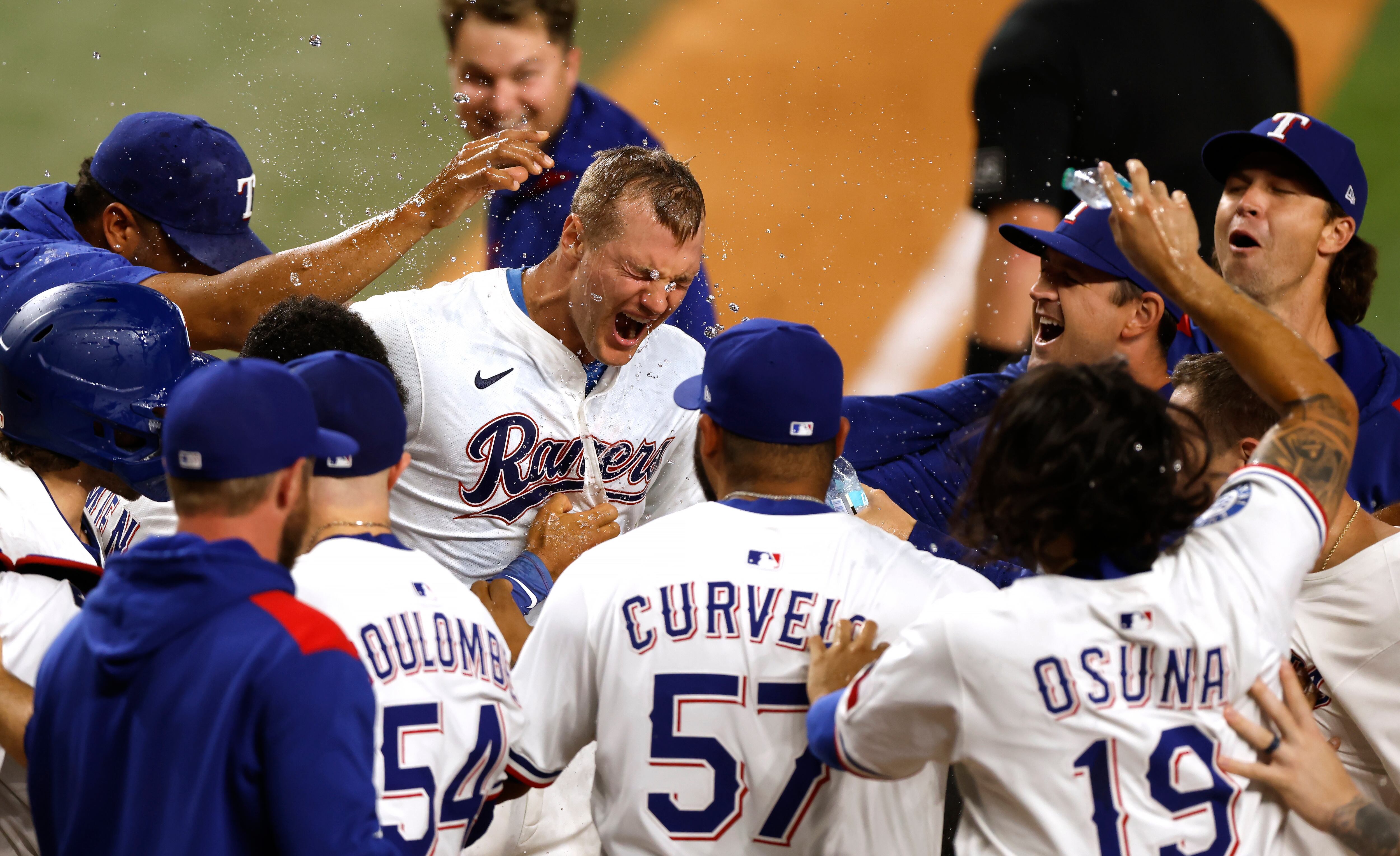 ARLINGTON, TX - AUGUST 4: Josh Jung #6 of the Texas Rangers celebrates with teammates after hitting a game winning walk-off three run home run against the New York Yankees during the tenth inning at Globe Life Field on August 4, 2025 in Arlington, Texas. (Photo by Ron Jenkins/Getty Images)