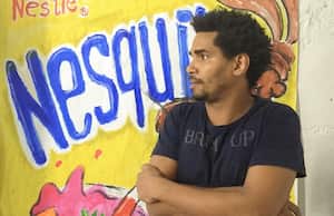 In this grab from an AFPTV video Cuban artist and dissident Luis Manuel Otero Alcantara speaks in front of one of his paintings in Havana on April 4, 2021. - A group of artists rebels in Cuba in solidarity with a dissident colleague who has been hospitalised for a month and is accused by the government of being financed by the United States. (Photo by - / AFPTV / AFP)