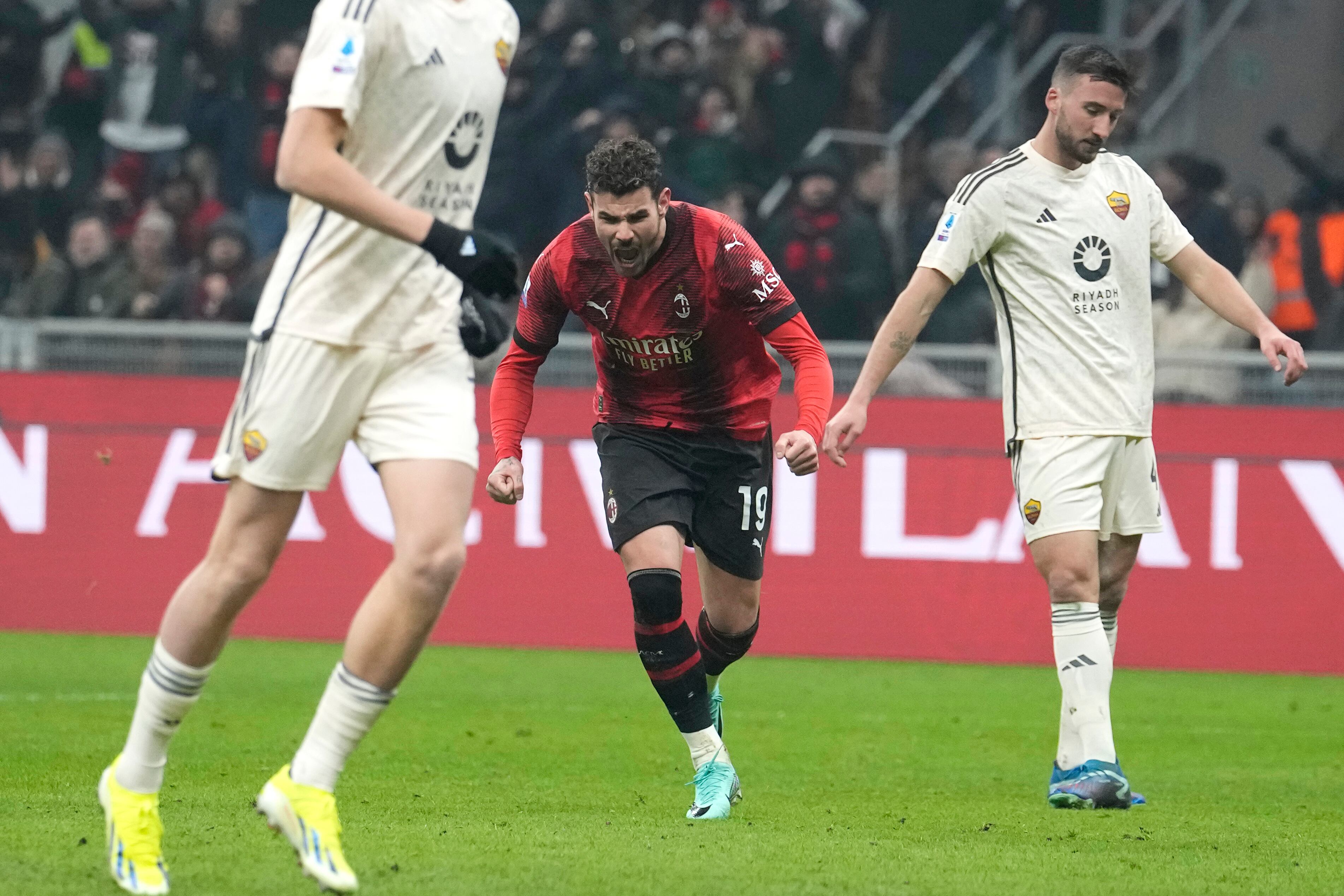 AC Milan's Theo Hernandez, centre, celebrates after scoring his side's third goal during the Serie A soccer match between AC Milan and Roma at the San Siro stadium in Milan, Italy, Sunday, Jan. 14, 2024. (AP Photo/Luca Bruno)