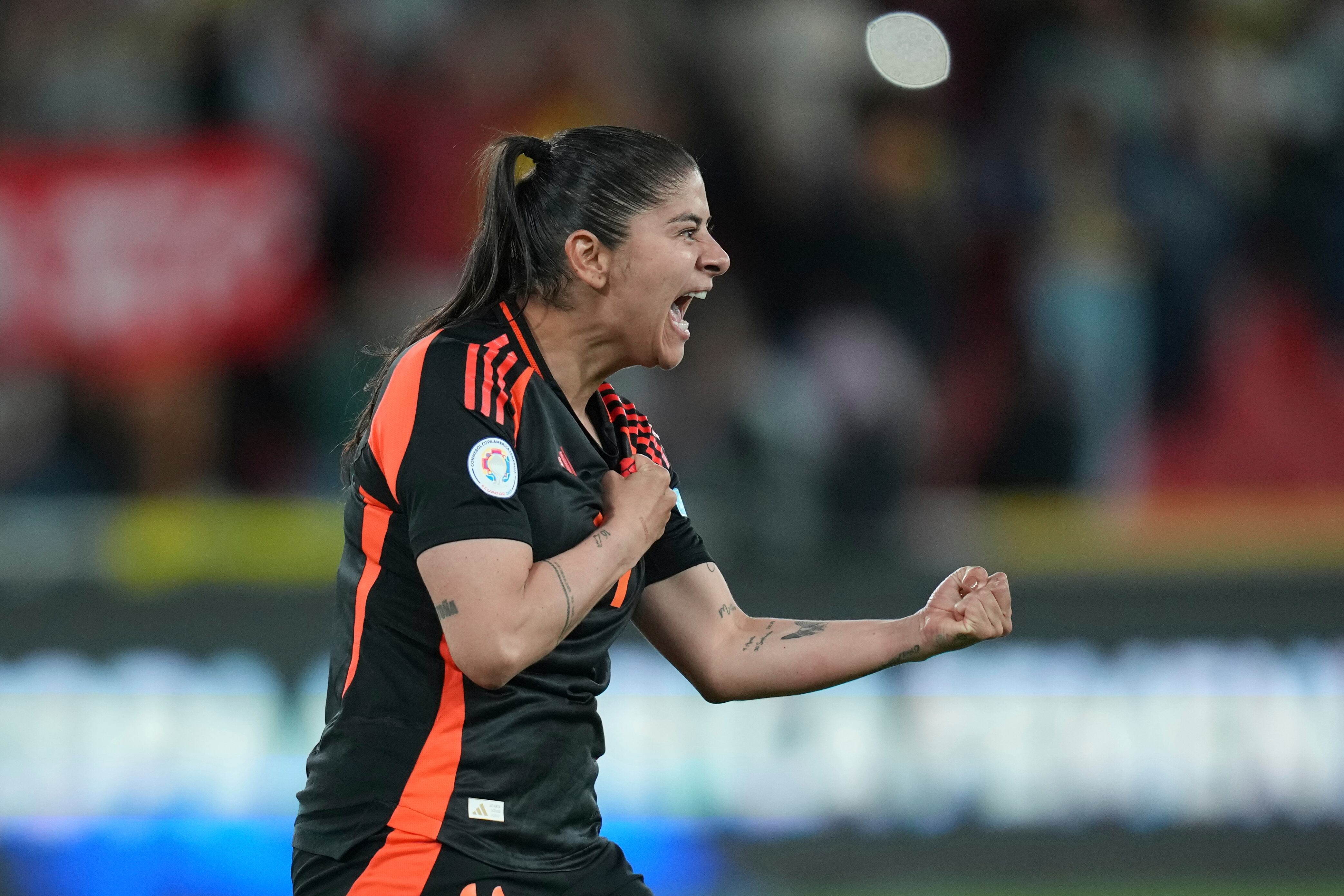 Colombia's Maria Usme celebrates after scoring in a penalty shootout against Argentina during a Women's Copa America semifinal soccer match at Rodrigo Paz Delgado stadium in Quito, Ecuador, Monday, July 28, 2025. (AP Photo/Dolores Ochoa)