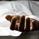 an Indian or Asian person laying dead with outstretched hand during COVID-19 or corona virus outbreak