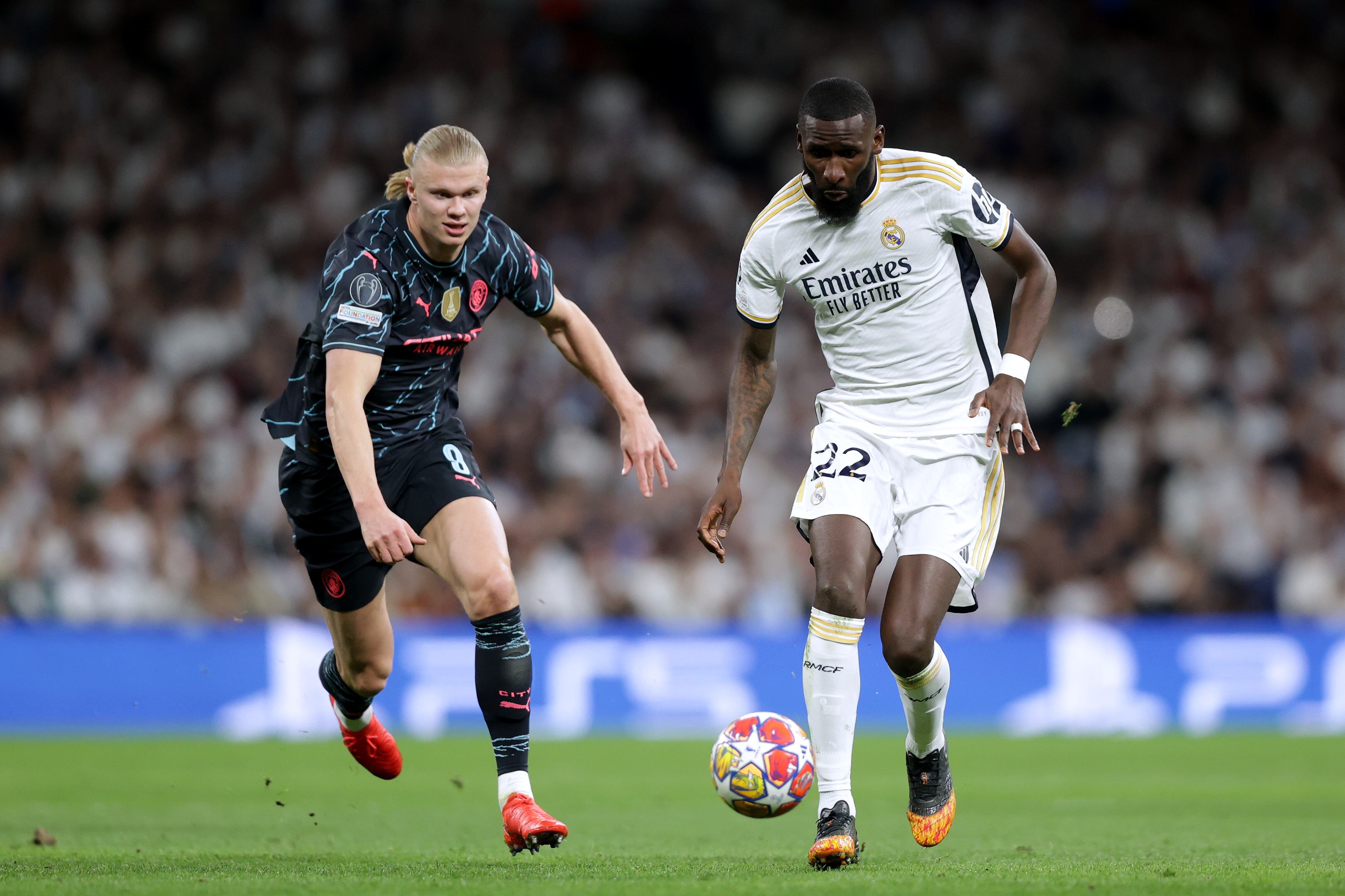MADRID, SPAIN - APRIL 09: Erling Haaland(L) of Manchester City FC competes for the ball with Antonio Rudiger (R) of Real Madrid CF during the UEFA Champions League quarter-final first leg match between Real Madrid CF and Manchester City at Estadio Santiago Bernabeu on April 09, 2024 in Madrid, Spain. (Photo by Gonzalo Arroyo - UEFA/UEFA via Getty Images)