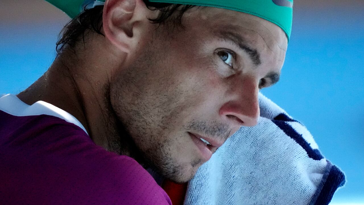Rafael Nadal of Spain wipes the sweat from his face during his fourth round match against Adrian Mannarino of France at the Australian Open tennis championships in Melbourne, Australia, Sunday, Jan. 23, 2022. (AP Photo/Simon Baker)