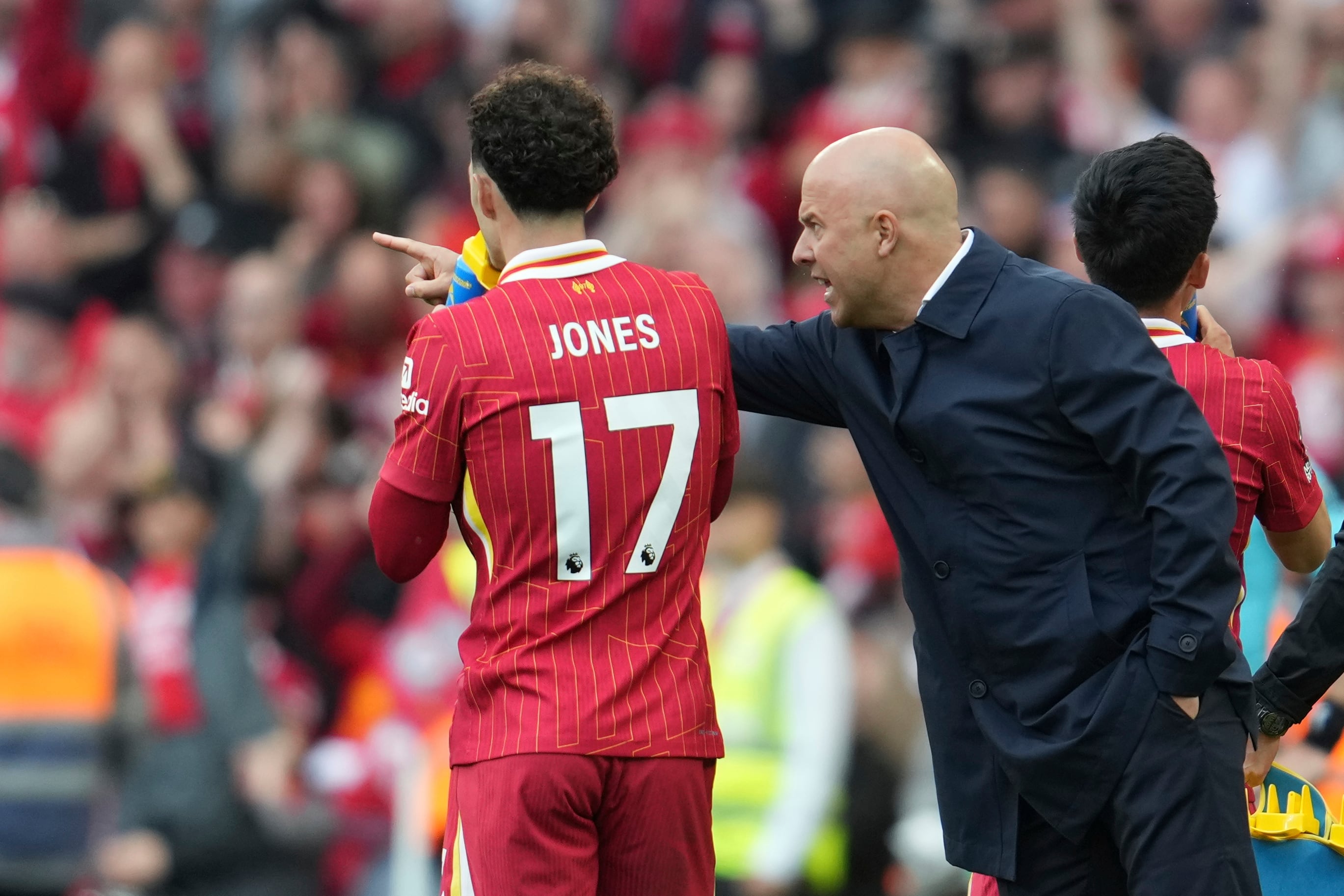 Liverpool's manager Arne Slot speaks to Liverpool's Curtis Jones during the English Premier League soccer match between Liverpool and Crystal Palace at the Anfield stadium in Liverpool, England, Sunday, May 25, 2025. (AP Photo/Jon Super)