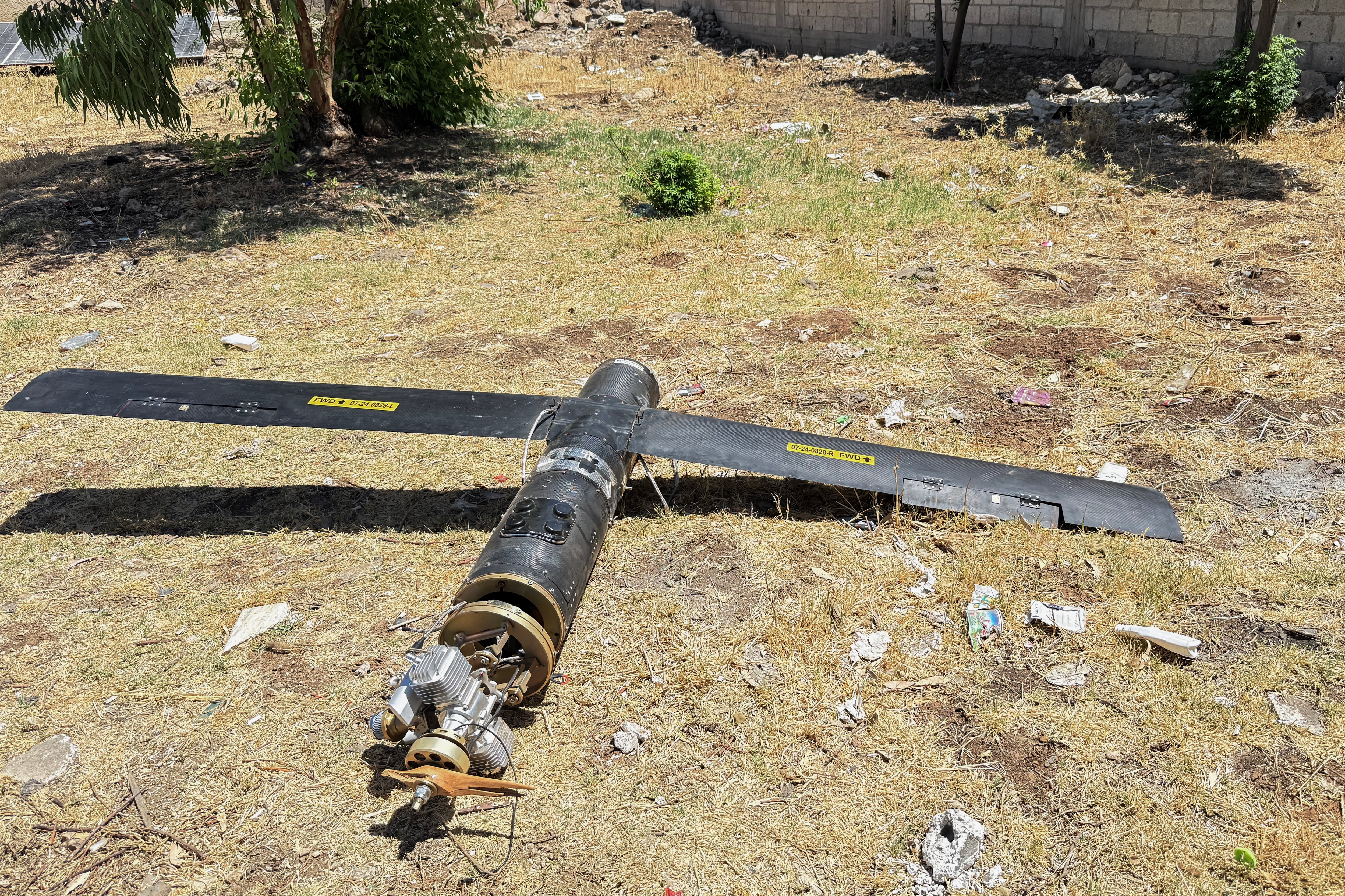A picture shows the remains of a drone that fell in the northern fields of Jasim city near Daraa in southwestern Syria on June 14, 2025. Israel and Iran exchanged fire on June 14, a day after Israel unleashed strikes that Iran said hit its nuclear facilities, "martyred" top commanders and killed dozens of civilians, only days before Iran and the United States had been due to hold a sixth round of talks on the Islamic republic's nuclear programme. (Photo by Sam HARIRI / AFP)