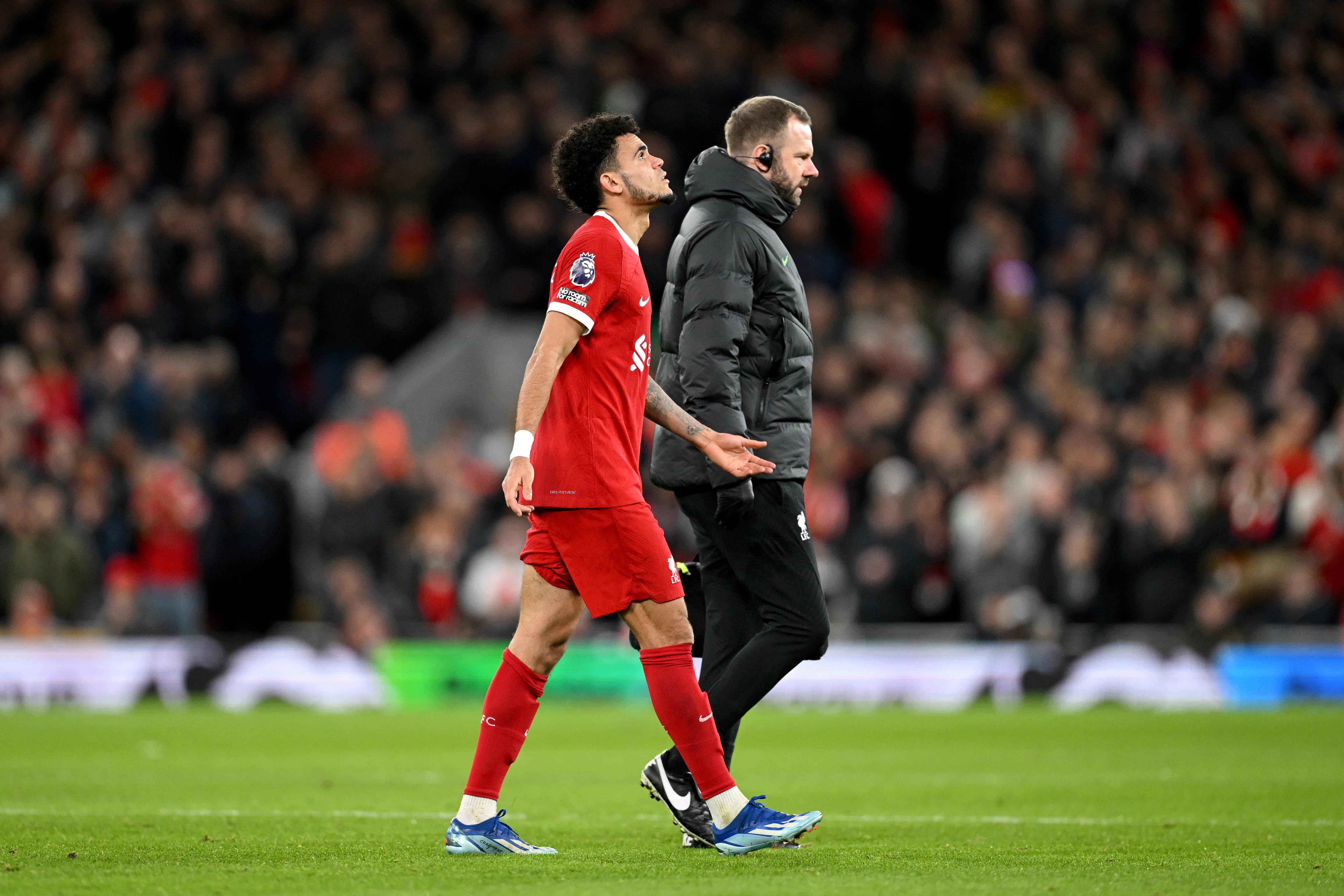 LIVERPOOL, ENGLAND - DECEMBER 23: Luis Diaz of Liverpool leaves the field after sustaining an injury during the Premier League match between Liverpool FC and Arsenal FC at Anfield on December 23, 2023 in Liverpool, England. (Photo by Michael Regan/Getty Images)