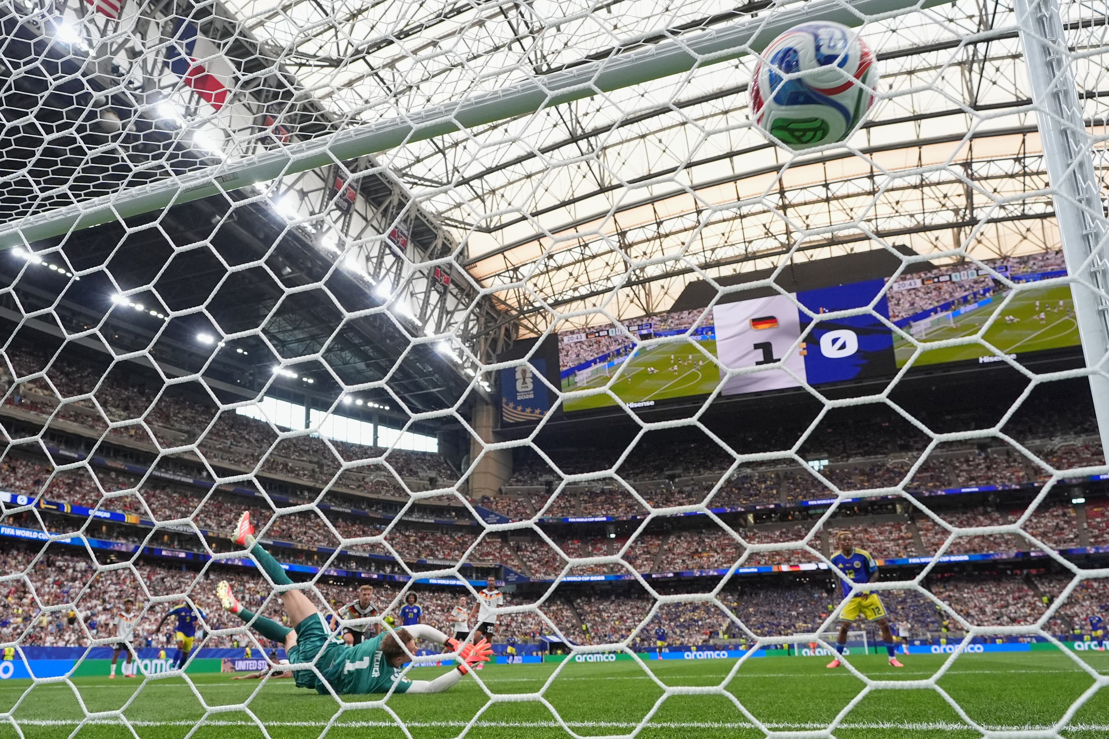 Germany goalkeeper Manuel Neuer (1) is beaten by a shot from Curaçao's Livano Comenencia (8) for the opening goal during the World Cup Group E soccer match between Germany and Curacao in Houston, Sunday, June 14, 2026. (AP Photo/Eric Gay)