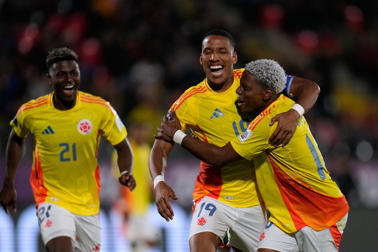 Colombia's Kener Gonzalez (19) celebrates with Colombia's Oscar Perea after scoring his side's opening goal against Nigeria during a FIFA U-20 World Cup Group F soccer match at Fiscal Stadium in Talca, Chile, Sunday, Oct. 5, 2025. (AP Photo/Matias Delacroix)