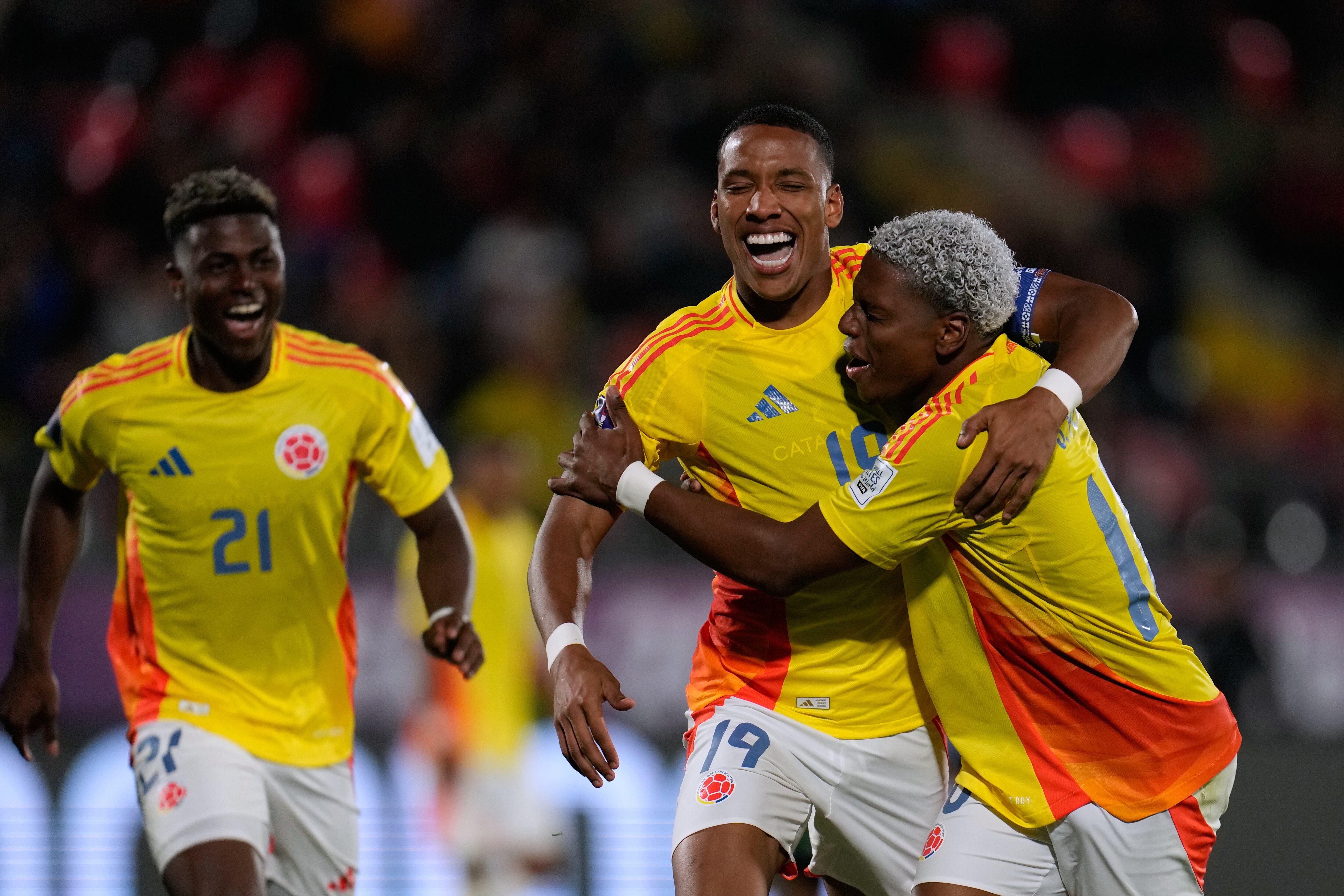 Colombia's Kener Gonzalez (19) celebrates with Colombia's Oscar Perea after scoring his side's opening goal against Nigeria during a FIFA U-20 World Cup Group F soccer match at Fiscal Stadium in Talca, Chile, Sunday, Oct. 5, 2025. (AP Photo/Matias Delacroix)