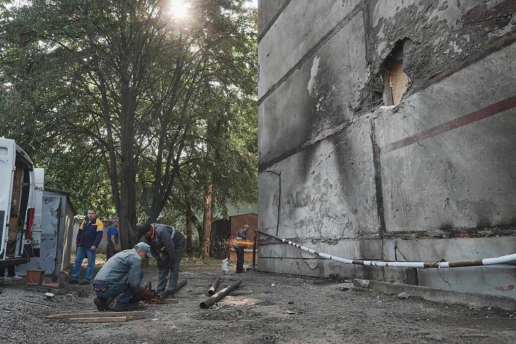 KHARKIV, UKRAINE - JUNE 5: Utility workers conduct repair works on pipe near damaged residential building after a Russian night drone attack on June 5, 2025 in Kharkiv, Ukraine. 18 People, including four children, suffered acute stress reactions due to the Russian attack on the Slobidskyi District of Kharkiv, the Kharkiv region police reported. (Photo by Viktoriia Yakymenko/Suspilne Ukraine/JSC "UA:PBC"/Global Images Ukraine via Getty Images)