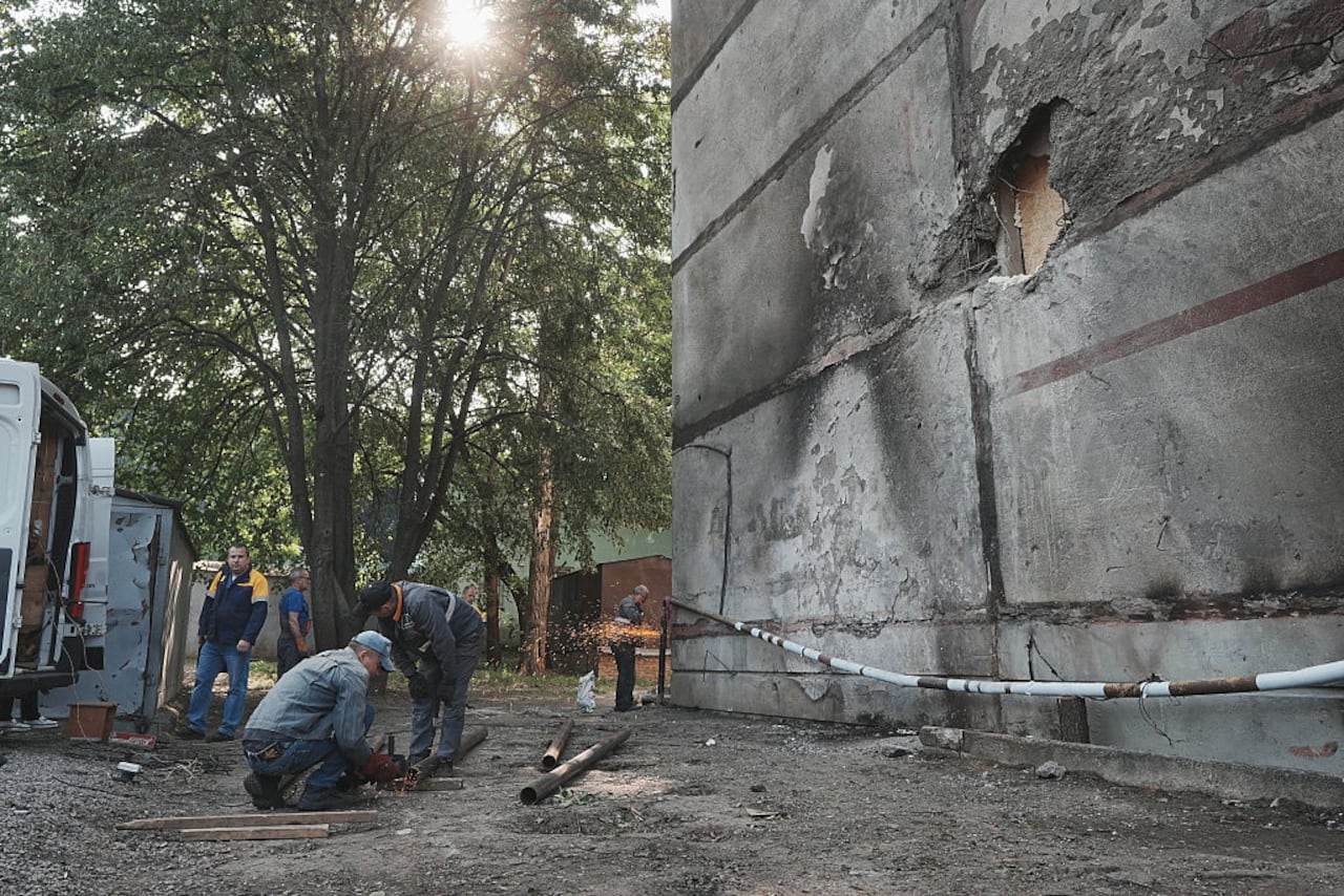 KHARKIV, UKRAINE - JUNE 5: Utility workers conduct repair works on pipe near damaged residential building after a Russian night drone attack on June 5, 2025 in Kharkiv, Ukraine. 18 People, including four children, suffered acute stress reactions due to the Russian attack on the Slobidskyi District of Kharkiv, the Kharkiv region police reported. (Photo by Viktoriia Yakymenko/Suspilne Ukraine/JSC "UA:PBC"/Global Images Ukraine via Getty Images)