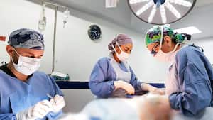 Los cirujanos plásticos Luis G. Figueroa e Isabel Uribe en un procedimiento médico.