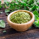 Fresh and dried oregano herb on wooden background