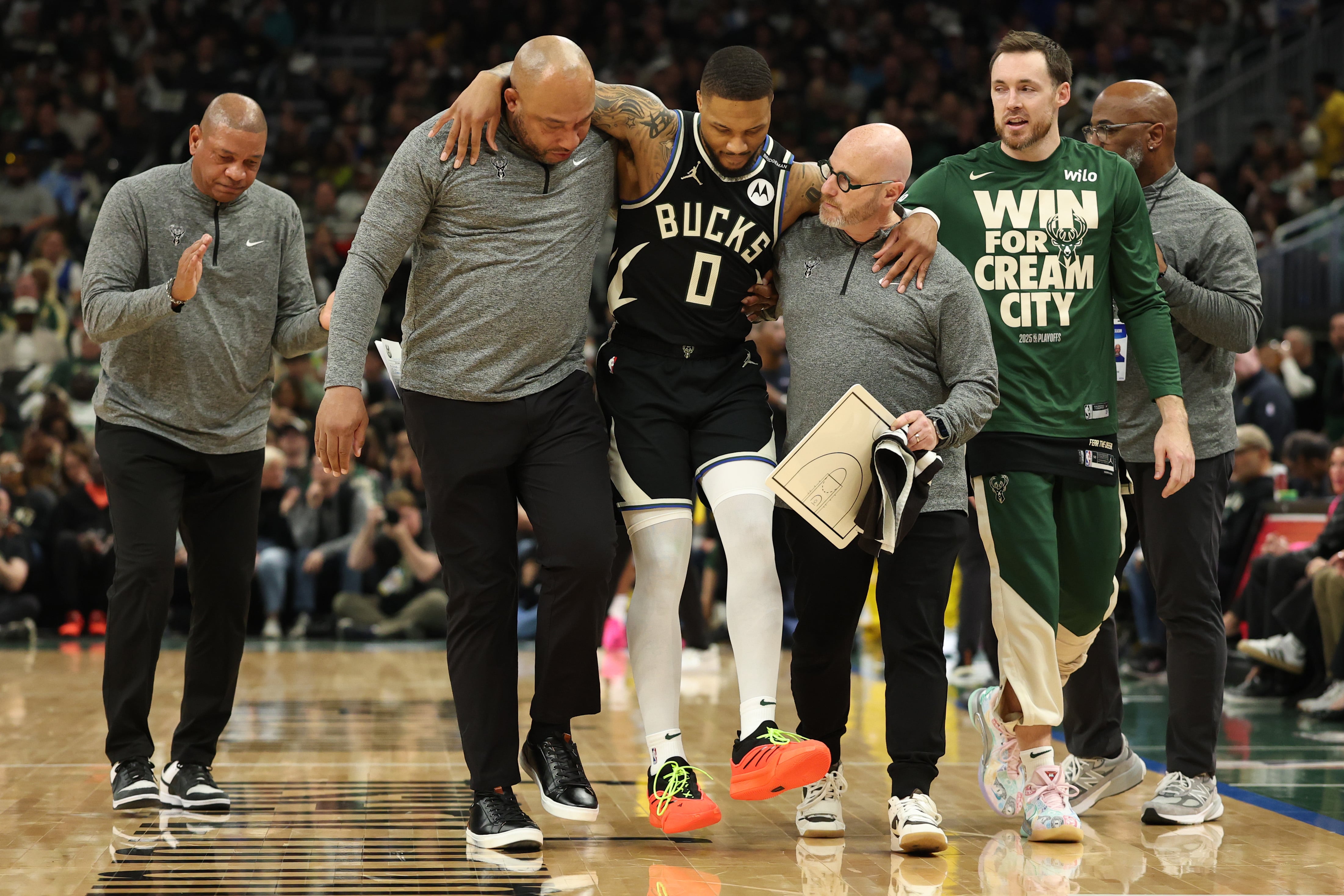 MILWAUKEE, WISCONSIN - APRIL 27: Damian Lillard #0 of the Milwaukee Bucks is helped off the court after an apparent injury during the first quarter in Game Four of the Eastern Conference First Round NBA Playoffs against the Indiana Pacers at Fiserv Forum on April 27, 2025 in Milwaukee, Wisconsin. NOTE TO USER: User expressly acknowledges and agrees that, by downloading and or using this photograph, User is consenting to the terms and conditions of the Getty Images License Agreement. (Photo by Stacy Revere/Getty Images)