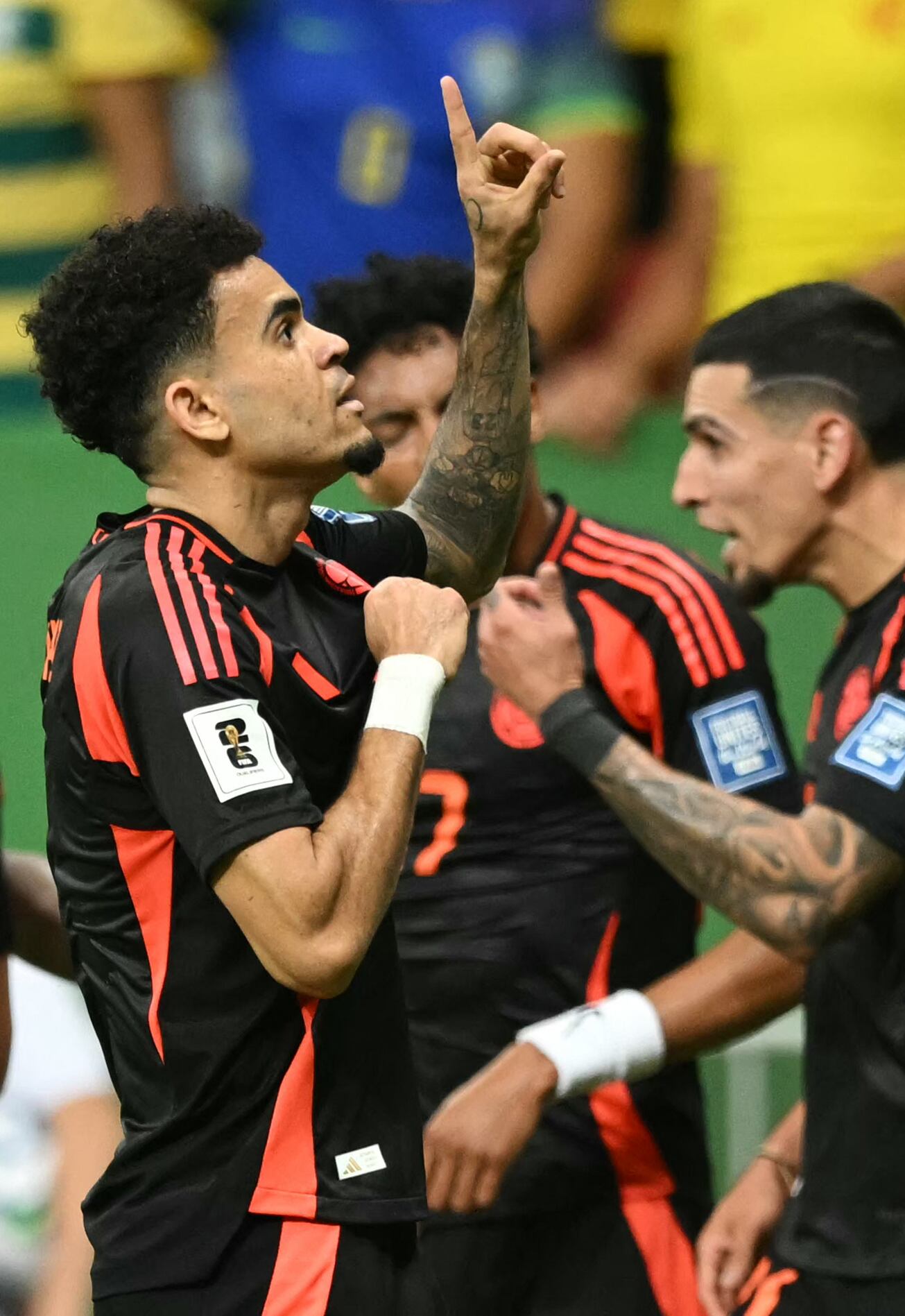 Colombia's forward #07 Luis Diaz (L) celebrates with teammates after scoring during the 2026 FIFA World Cup South American qualifiers football match between Brazil and Colombia, at the Mane Garrincha stadium in Brasilia, on March 20, 2025. (Photo by EVARISTO SA / AFP)