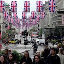 Union flags are raised to celebrate the upcoming coronation of King Charles III, in central London, Wednesday, April 26, 2023. (AP Photo/Kin Cheung)