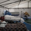 Un trabajador de la salud atiende a un paciente con COVID-19 en una carpa instalada en la cancha de fútbol del Hospital Samaritana, en Bogotá. (Foto AP / Ivan Valencia)