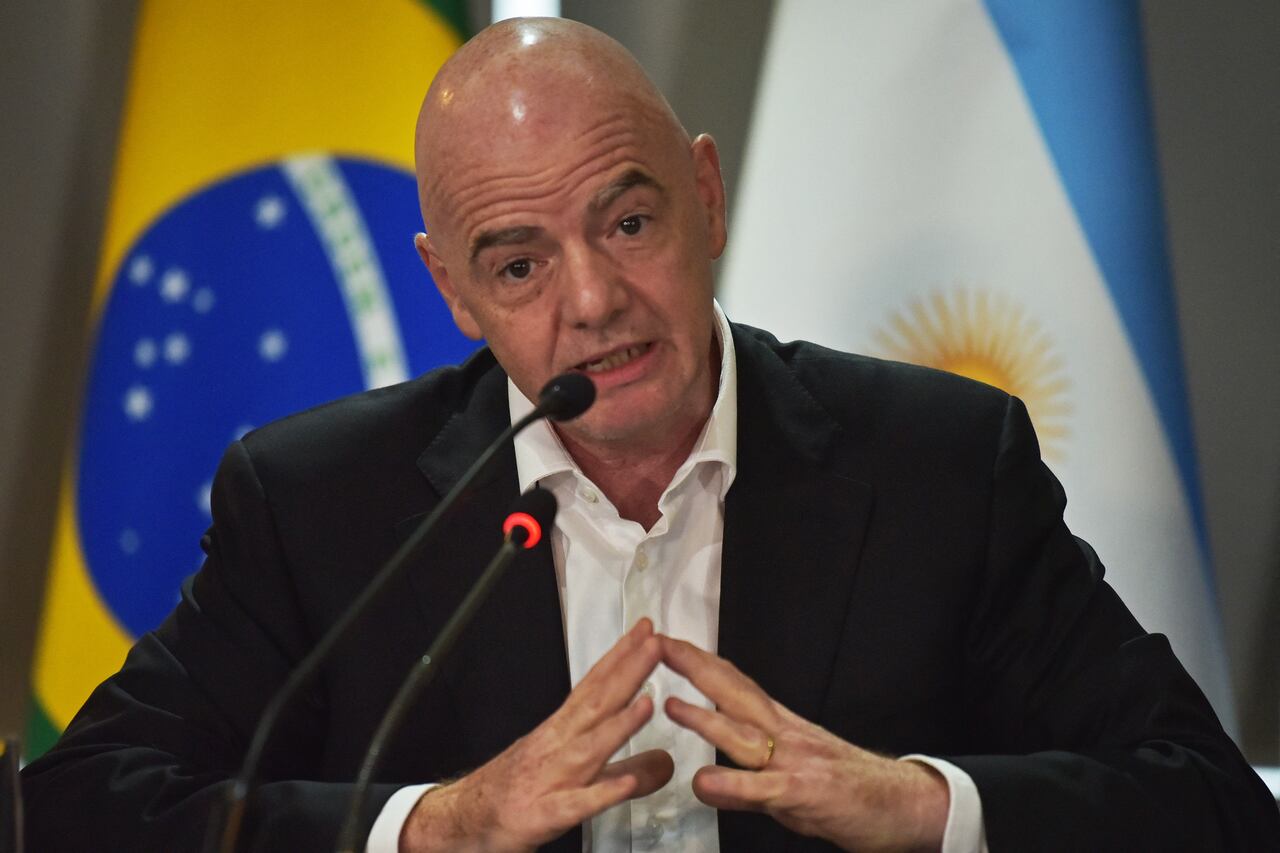 FIFA President Gianni Infantino (L) speaks next to the president of Conmebol, Paraguayan Alejandro Dominguez (out of frame), during a press conference at Conmebol's headquarters in Luque, Paraguay, on March 30, 2023. (Photo by NORBERTO DUARTE / AFP)
