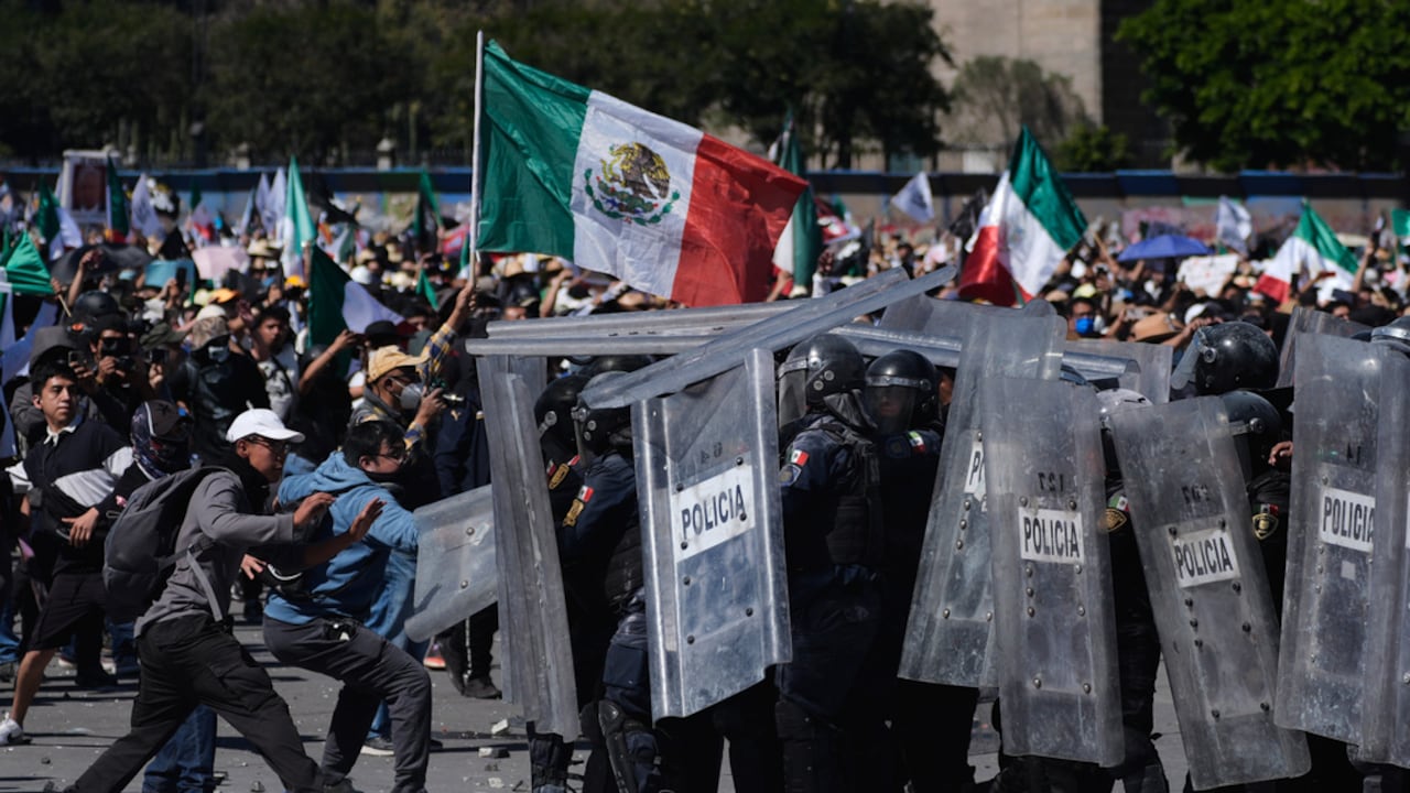 Manifestantes cargan contra la policía durante una marcha juvenil antigubernamental en la Ciudad de México.