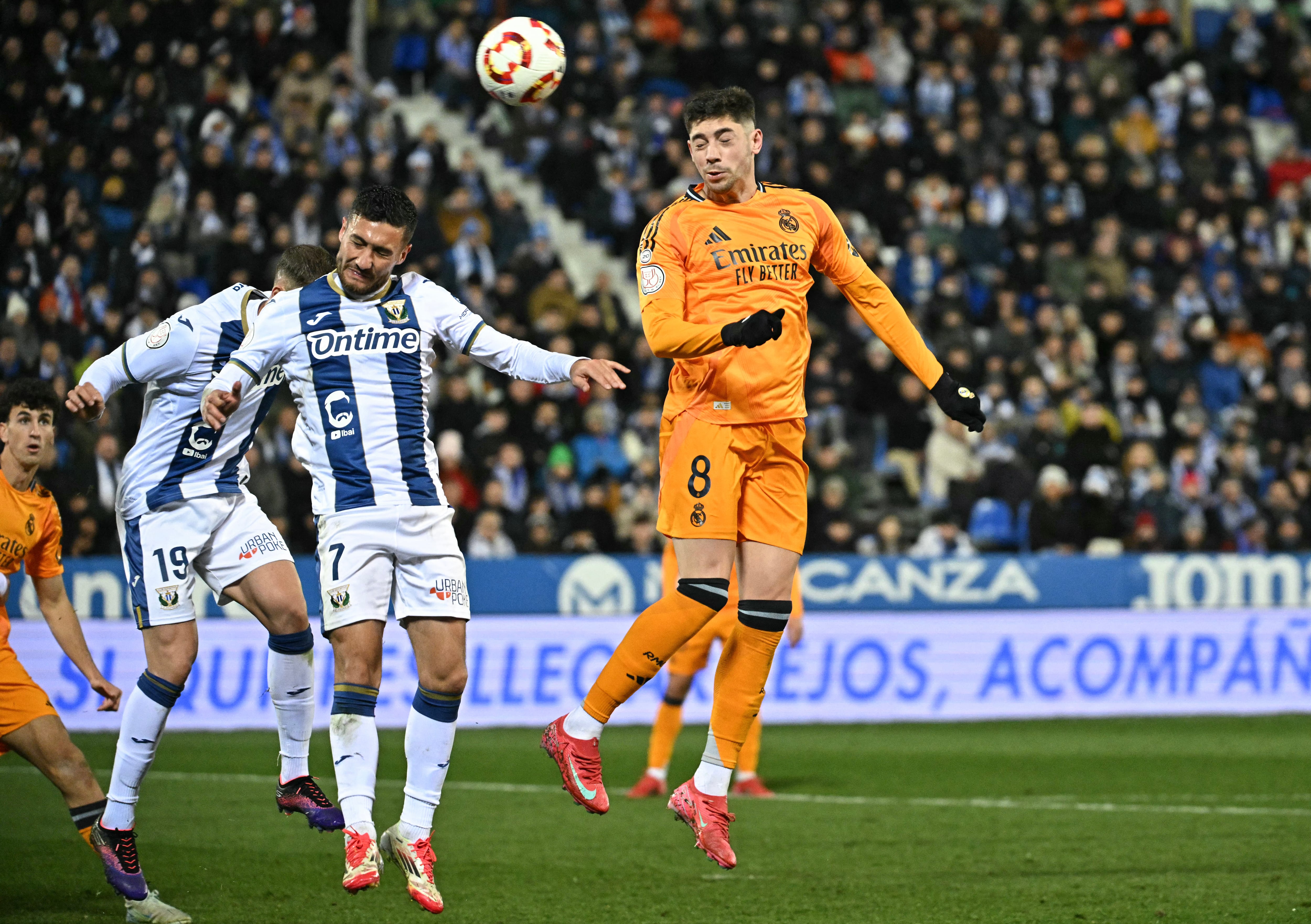 Real Madrid's Uruguayan midfielder #08 Federico Valverde (R) goes for a header with Leganes' Spanish midfielder #07 Oscar Rodriguez during the Spanish Copa del Rey (King's Cup) quarter-final first leg football match between Club Deportivo Leganes SAD and Real Madrid CF at Butarque Municipal Stadium in Leganes on February 5, 2025. (Photo by JAVIER SORIANO / AFP)