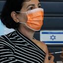 An Israeli woman receives a Pfizer-BioNTech coronavirus vaccine at a vaccination center in Tel Aviv, Israel, Tuesday, Feb. 2, 2021. (AP Photo/Sebastian Scheiner)