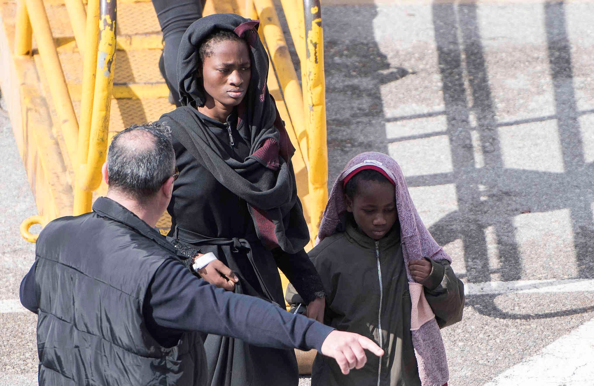 Una mujer junto con su hijo salen del barco. Ambos llegaron de un campamento de refugiados en Libia, en donde se cree que hay torturas, violaciones y esclavitud constantemente, según organizaciones de derechos humanos. Foto: Rene' Rossignaud/AP. 