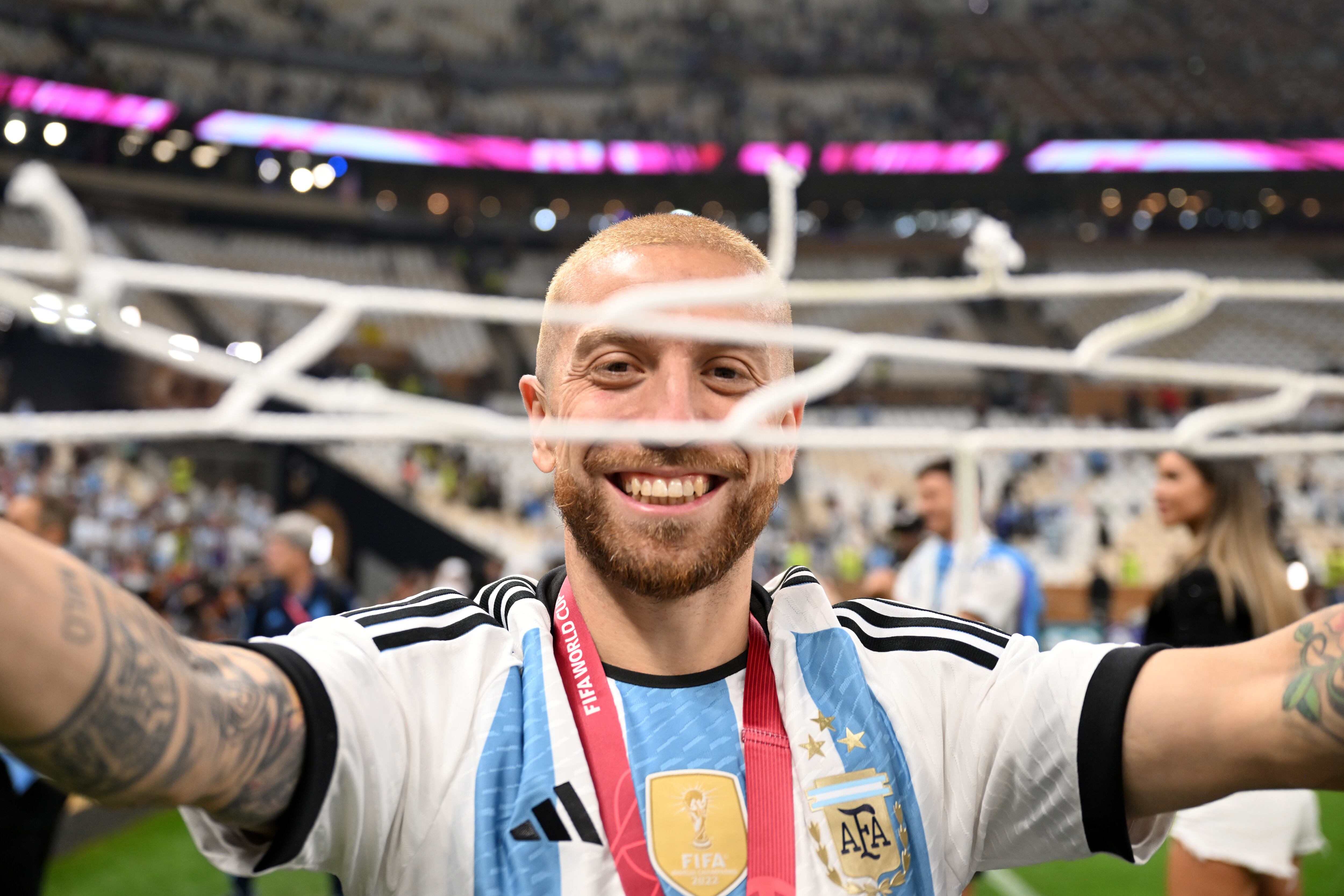 LUSAIL CITY, QATAR - DECEMBER 18: Alejandro Gomez of Argentina celebrates after the team's victory with a piece of the net during the FIFA World Cup Qatar 2022 Final match between Argentina and France at Lusail Stadium on December 18, 2022 in Lusail City, Qatar. (Photo by Michael Regan - FIFA/FIFA via Getty Images)