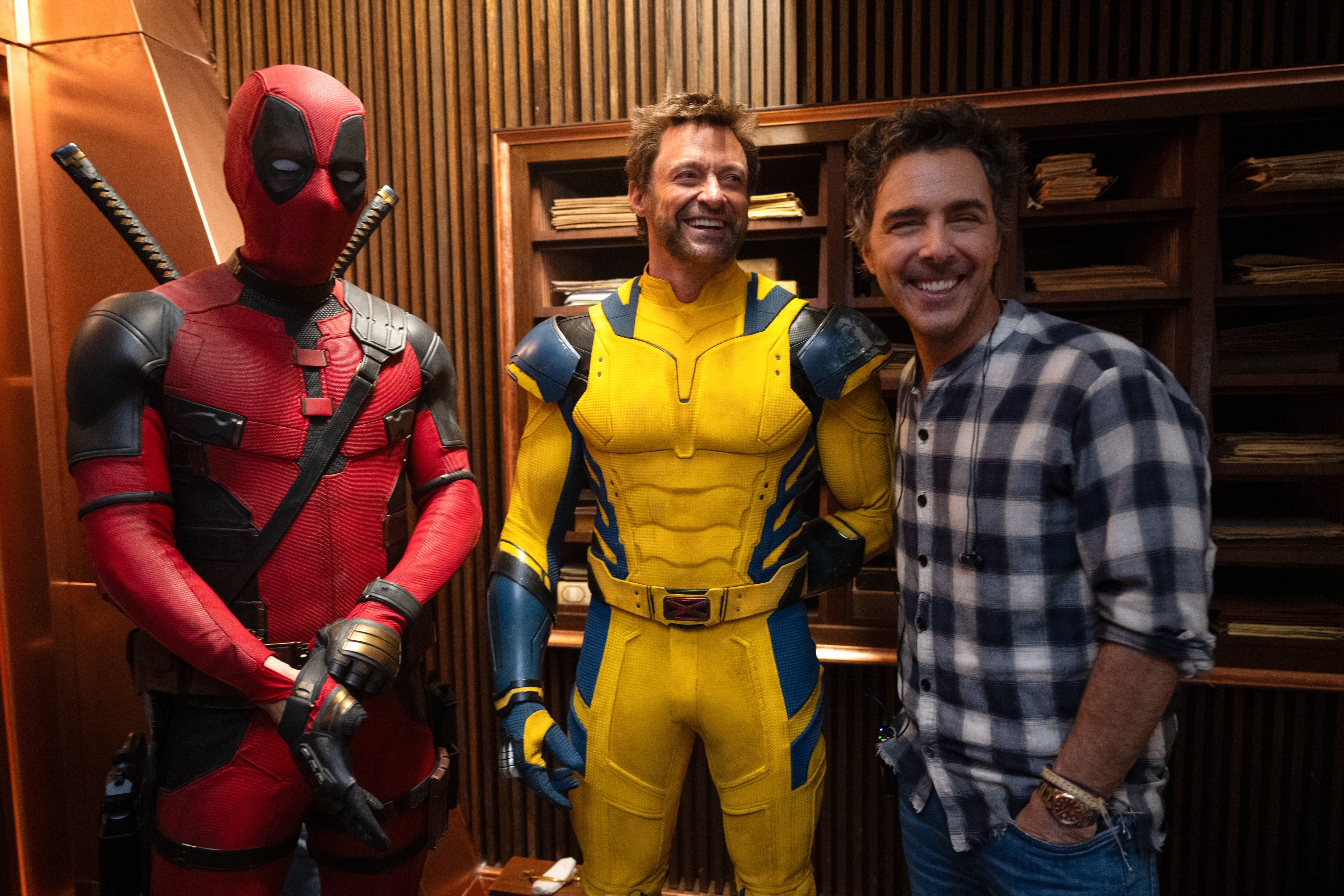 (L-R): Ryan Reynolds, Hugh Jackman, and Director Shawn Levy on the set of Marvel Studios' DEADPOOL & WOLVERINE. Photo by Jay Maidment. © 2024 20th Century Studios / © and ™ 2024 MARVEL.