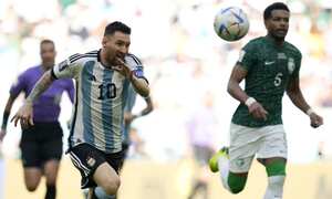 Argentina's Lionel Messi, left, and Saudi Arabia's Mohammed Al-Burayk run for the ball during the World Cup group C soccer match between Argentina and Saudi Arabia at the Lusail Stadium in Lusail, Qatar, Tuesday, Nov. 22, 2022. (AP Photo/Ricardo Mazalan)
