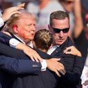 Republican presidential candidate former President Donald Trump is helped off the stage at a campaign event in Butler, Pa., on Saturday, July 13, 2024. (AP Photo/Gene J. Puskar)
