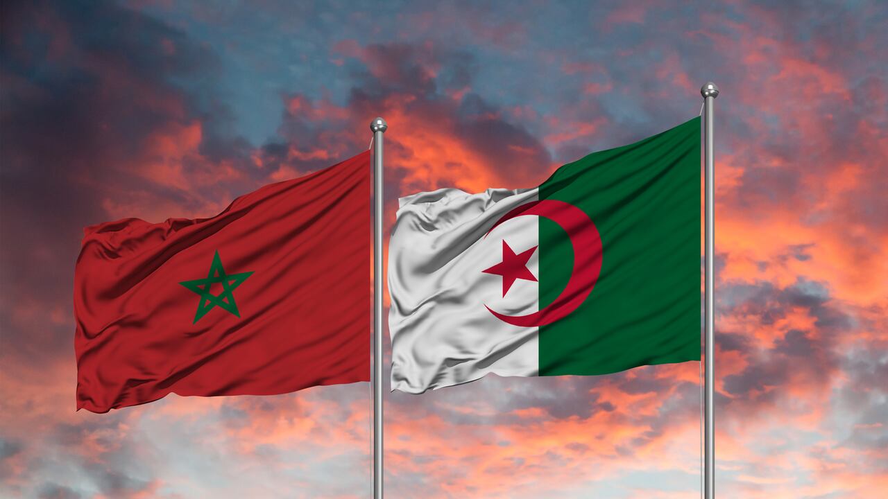 Flag of Morocco and Algeria waving together in the blue sky
