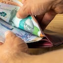 Hand taking money out of wallet, Colombia Peso banknotes, Concept, rising prices, value of Colombian currency