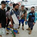 Venezuelan migrant Cristian Casamayor, second from left, arrives to Necocli, Colombia with fellow Venezuelan migrants after they decided against crossing the Darien Gap and returned from Acandi, Thursday, Oct. 13, 2022. Some Venezuelans are reconsidering their journey to the U.S. after the U.S. announced on Oct. 12 that Venezuelans who walk or swim across the border will be immediately returned to Mexico without rights to seek asylum. (AP Photo/Fernando Vergara)