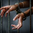 Prisoner in prison with handcuff