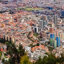 Bogota, Colombia - Looking at the downtown area of the Andean capital city of Bogota, Colombia in South America, from the mountain peak called Monserrate. Concrete towers, churches, plazas, roads and streets can all be seen. The red terracotta roof tiled buildings to the left of the image are located in La Candelaria, which is the oldest and historic part of the city. The area has many building in the colonial Spanish style of architecture. To the right are the modern towers in the City. The street called Las Aguas is clearly seen. Image demonstrates the old and the new, in significant contrast. Located at over 8500 feet above mean sea level, it is one of the largest cities in Latin America. Photo shot in the morning sunlight. Horizontal format.