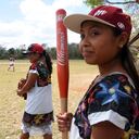 Players of "Las Diablillas de Hondzonot", wait for their turn to play during a softball match against "Guerreras de Piste", in Hondzonot, municipality of Tulum, Quintana Roo State, Mexico, on April 3, 2021. - Barefoot and in finely embroidered white dresses, a group of indigenous women leap onto the diamond. They are Las Diablillas de Hondzonot, a softball team that defies stereotypes in a community in southeastern Mexico. (Photo by ELIZABETH RUIZ / AFP)
